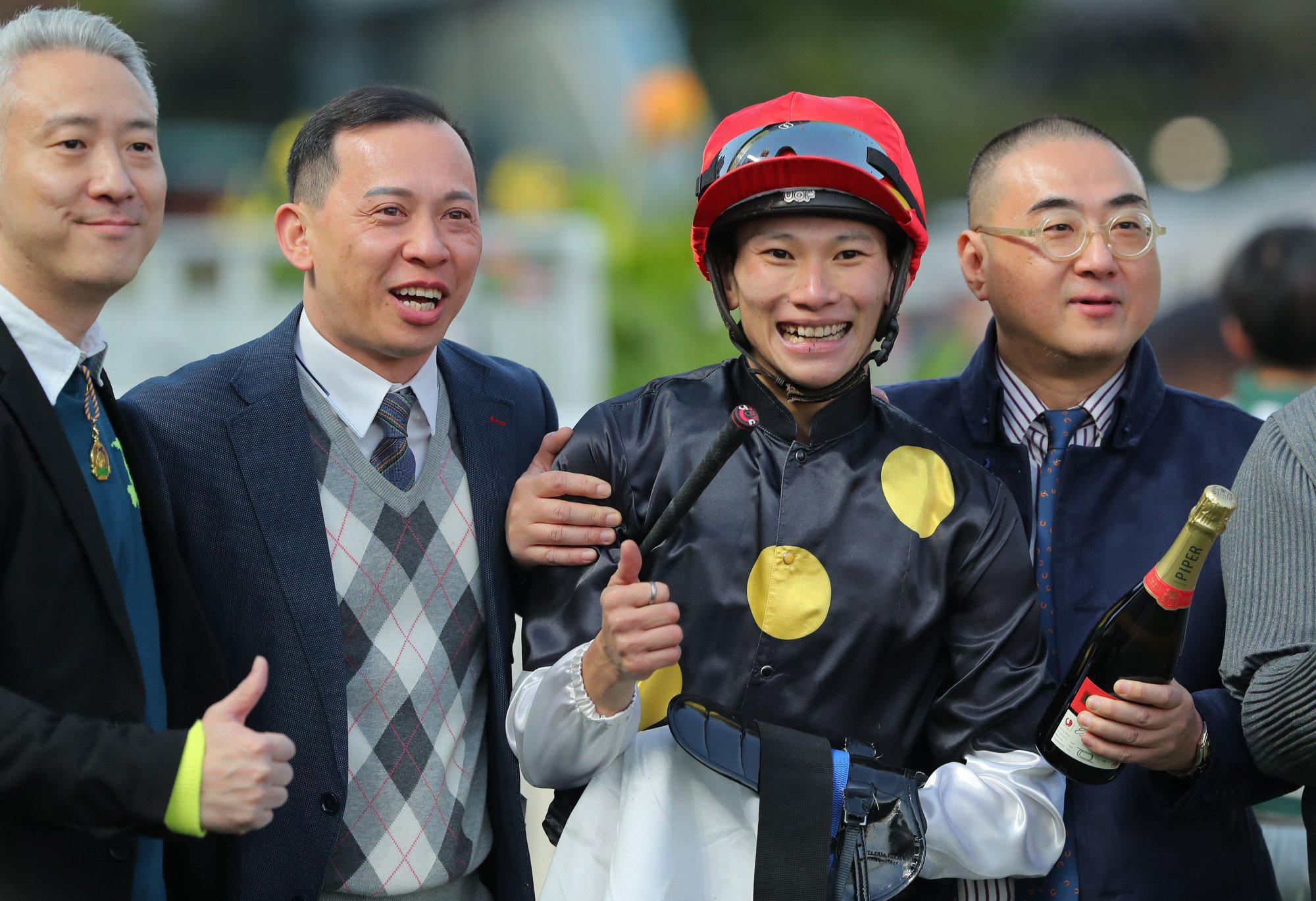 Trainer Cody Mo (second from left) and jockey Jerry Chau enjoy the win of Embraces.