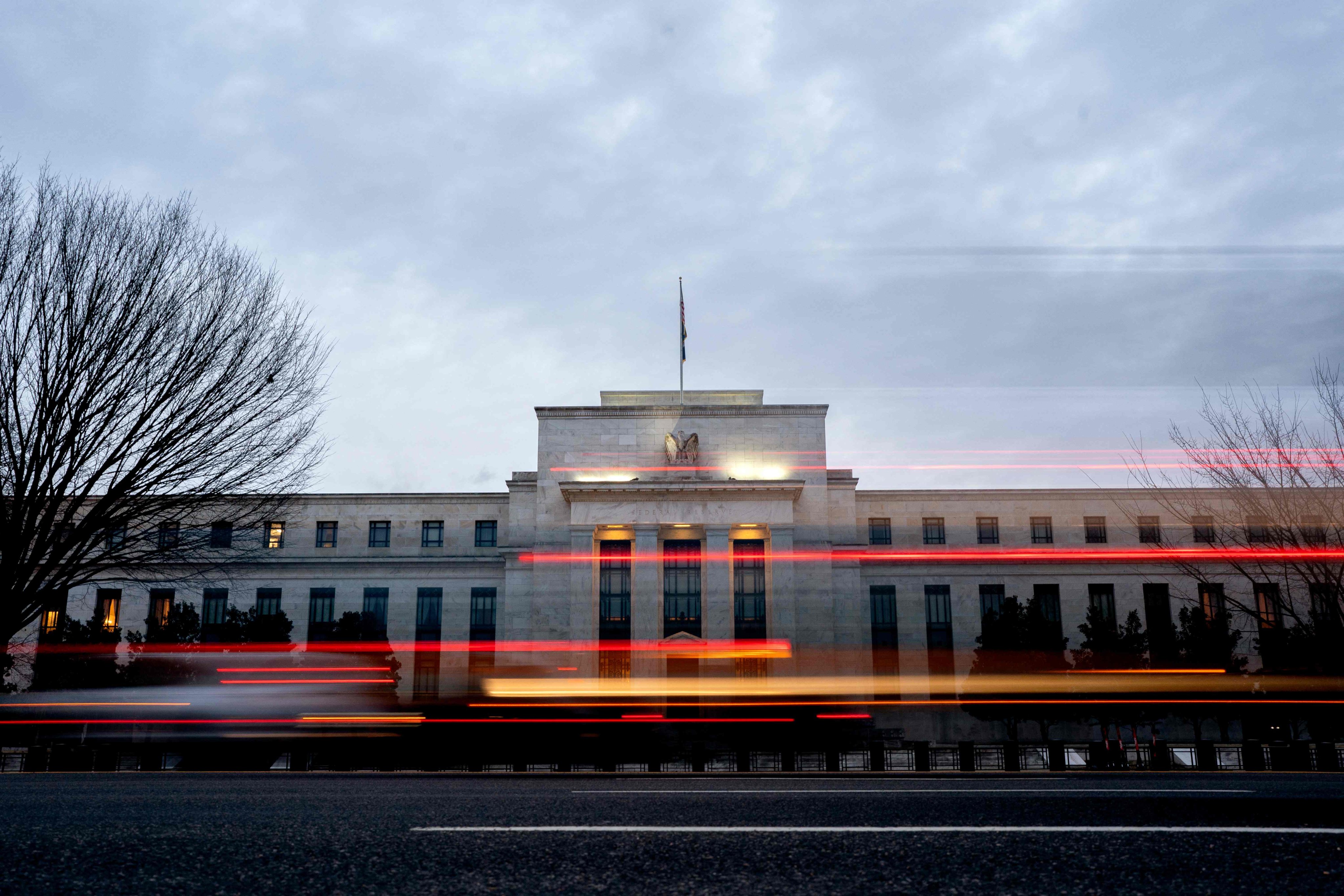 Vehicles drive past the Marriner S. Eccles Federal Reserve building in Washington, DC. Photo: AFP