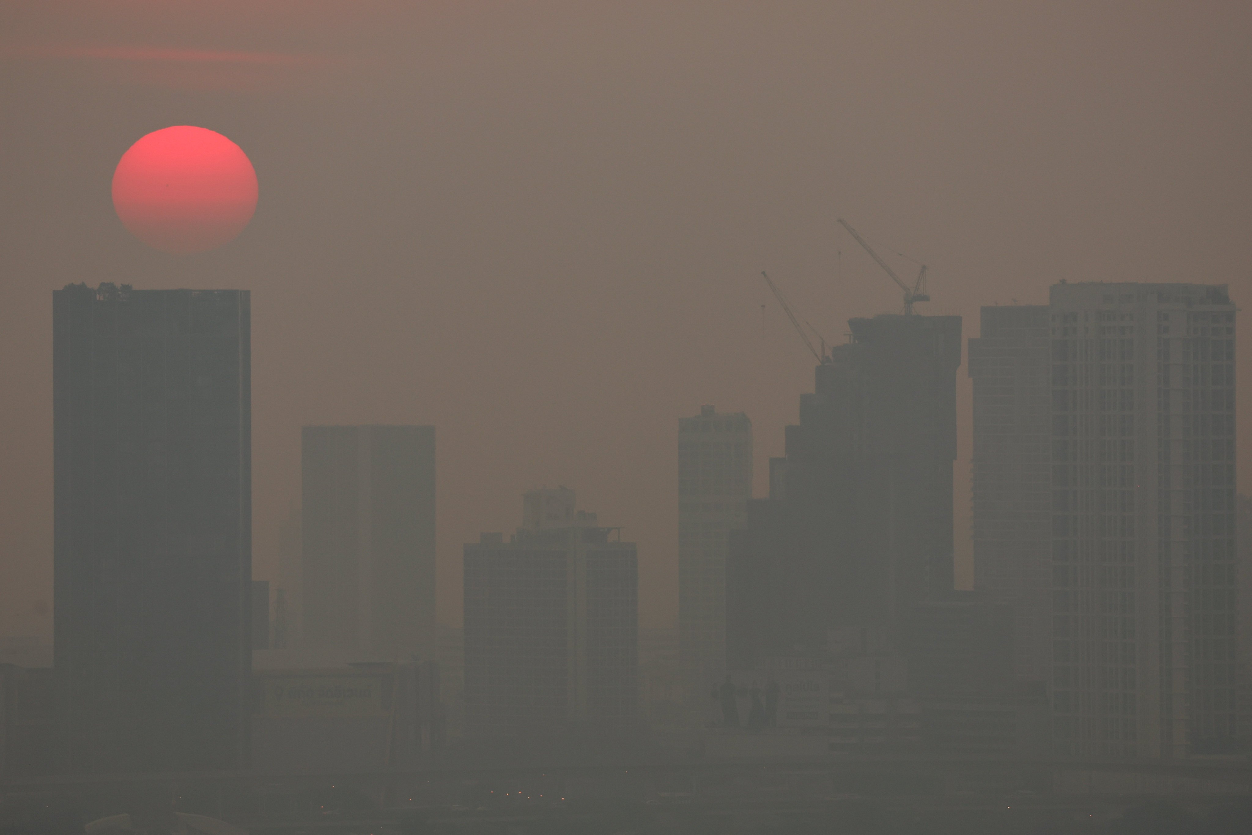 The sun rises above buildings shrouded by smog in Bangkok, Thailand, on Wednesday last week. Photo: Reuters