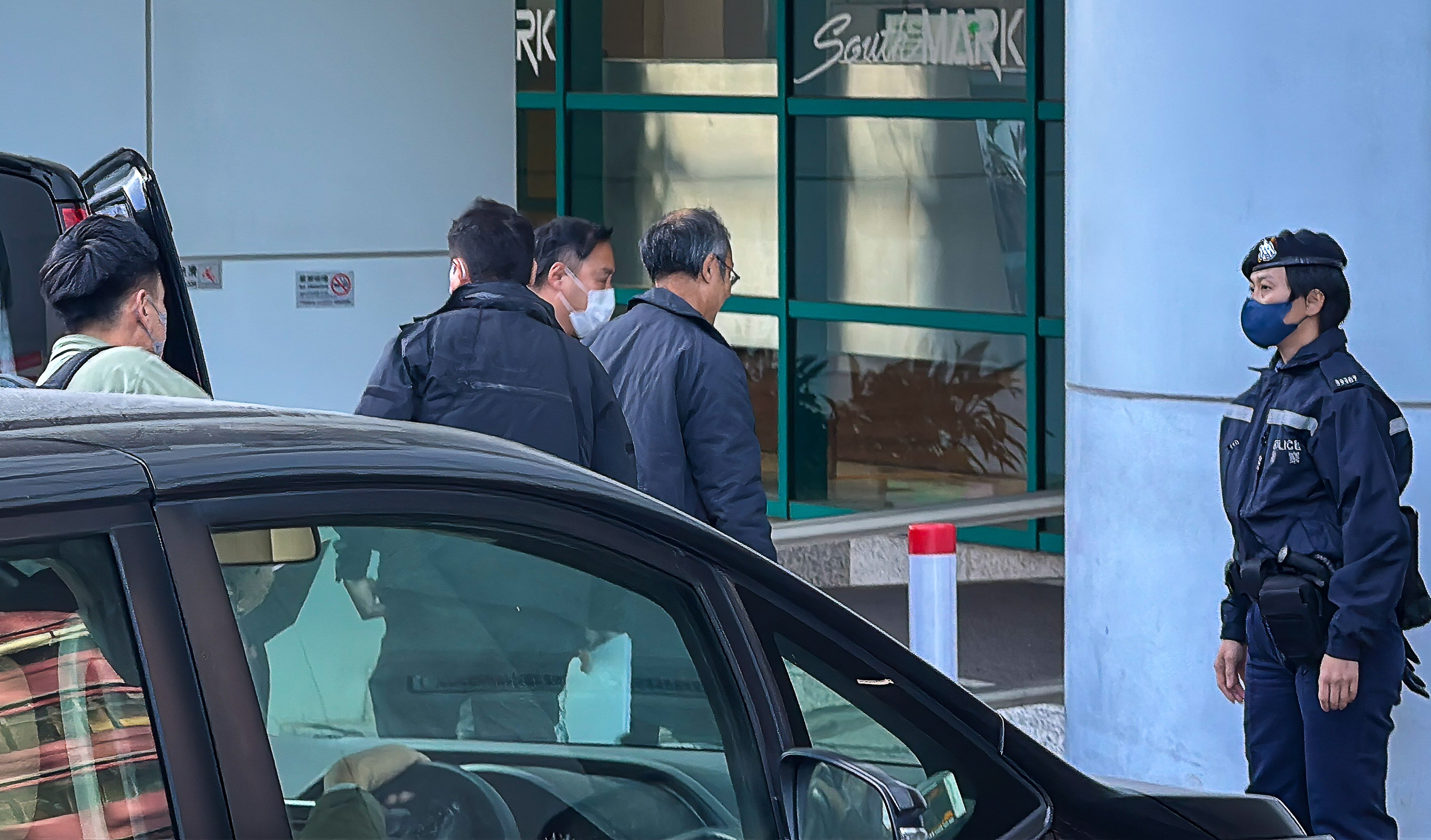 President of the Hong Kong Public Opinion Research Institute Robert Chung (3rd left) has been taken away for investigation. Photo: handout