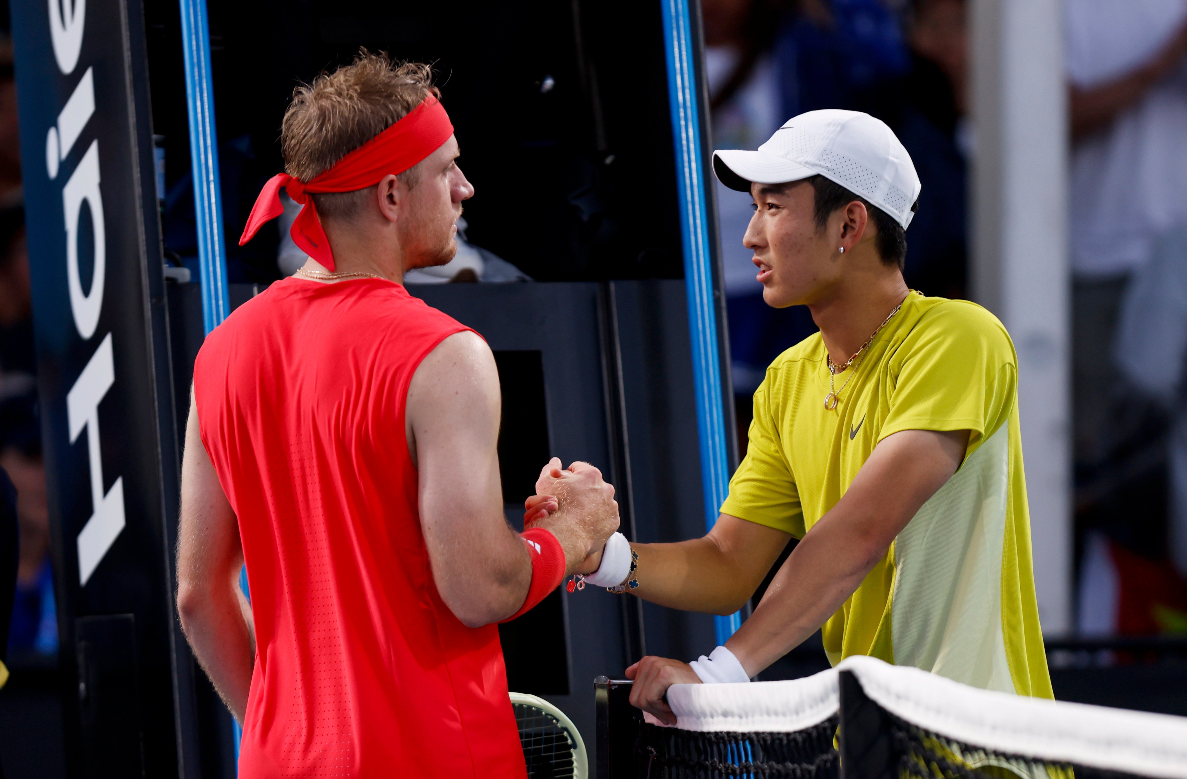 China’s Jerry Shang (right) shakes hands with Davidovich Fokina of Spain after retiring early during their first-round match. Photo: Xinhua