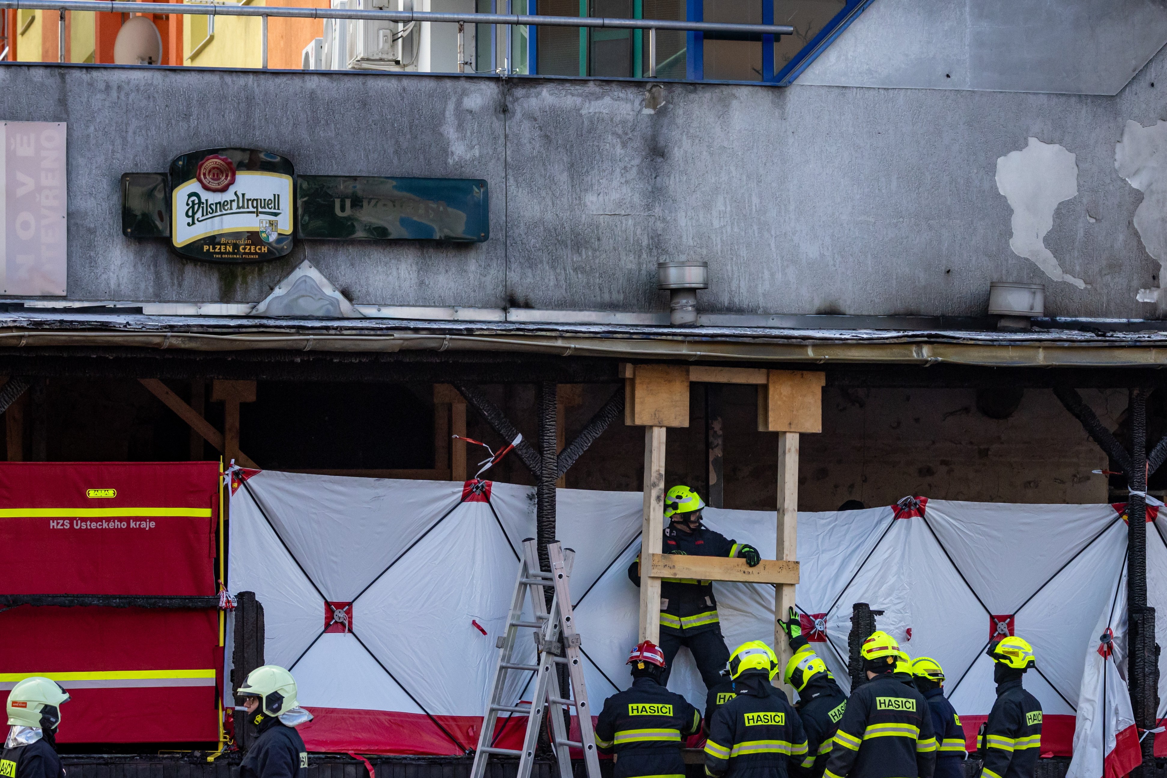 Firefighters and security forces check the scene of the burnt restaurant damaged by a propane-butane cylinder explosion in Most, Czech Republic on Sunday. Photo:  EPA-EFE