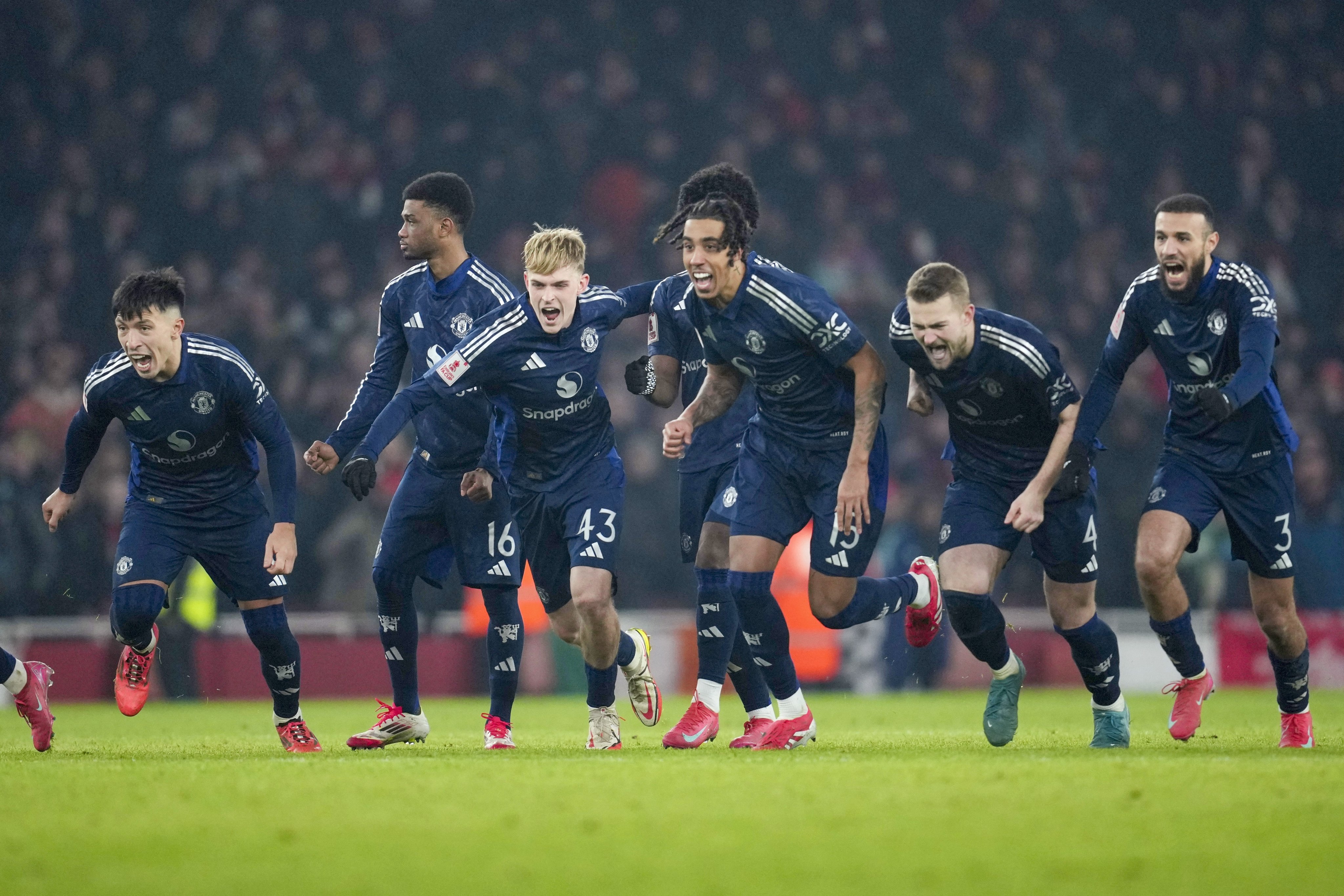 Manchester United’s players celebrate after winning their FA Cup penalty shootout against Arsenal. Photo: AP