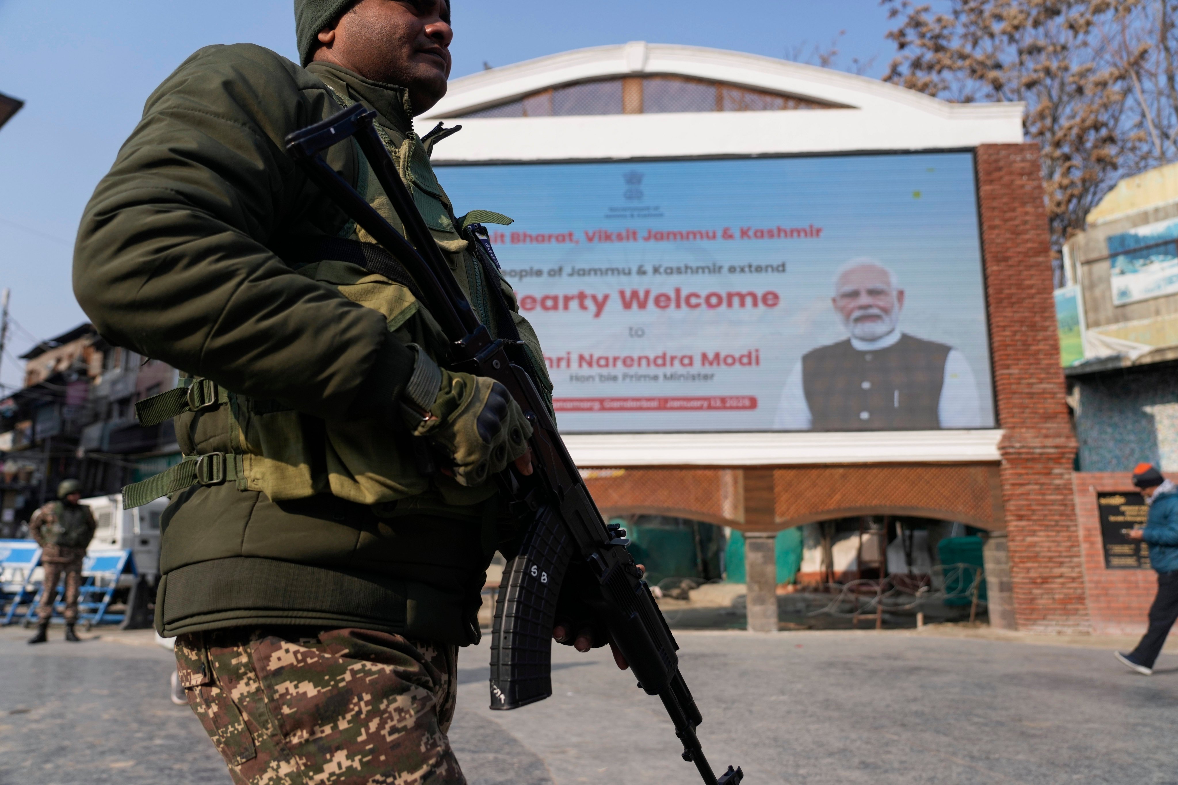 An Indian paramilitary soldier patrols near an electronic display in Srinagar welcoming Indian Prime Minister Narendra Modi to inaugurate a strategic tunnel project that connects Kashmir with Ladakh on Monday. Photo: AP