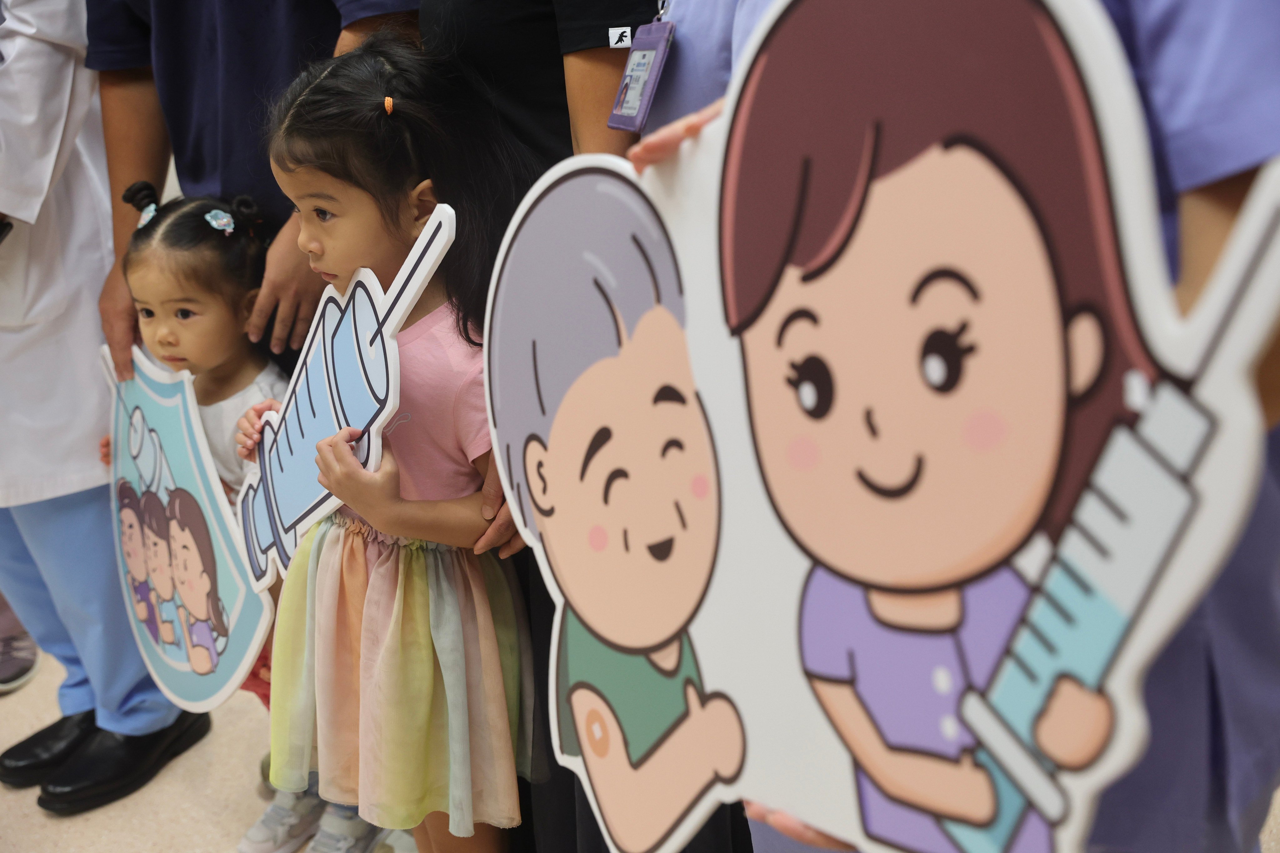 Two young girls are seen as the Hospital Authority holds a press conference on flu vaccine in Kwun Tong. Photo: Edmond So