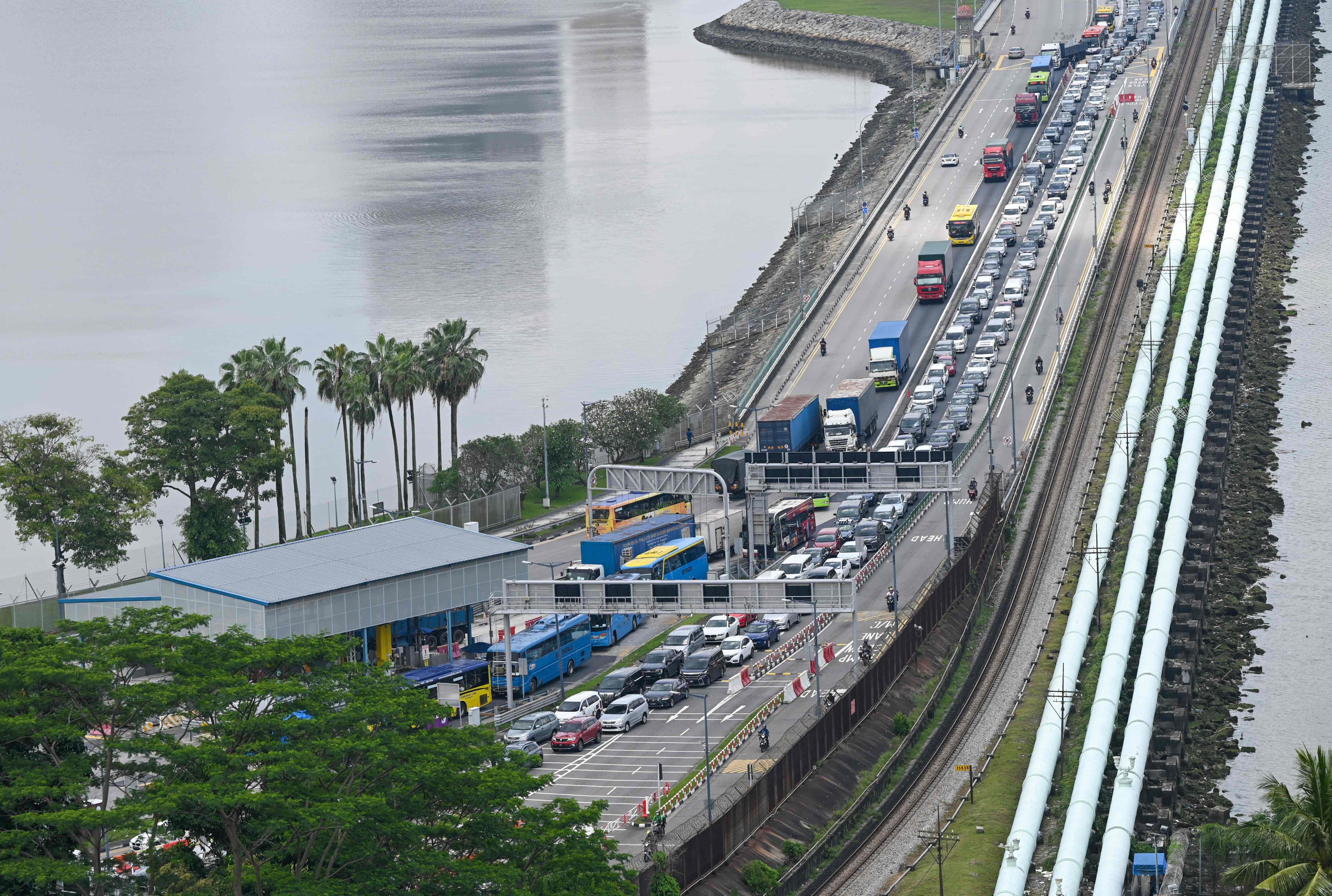 Vehicles coming from Johor Bahru in Malaysia queue near an immigration checkpoint to enter Singapore on March 31, 2023. Photo: AFP