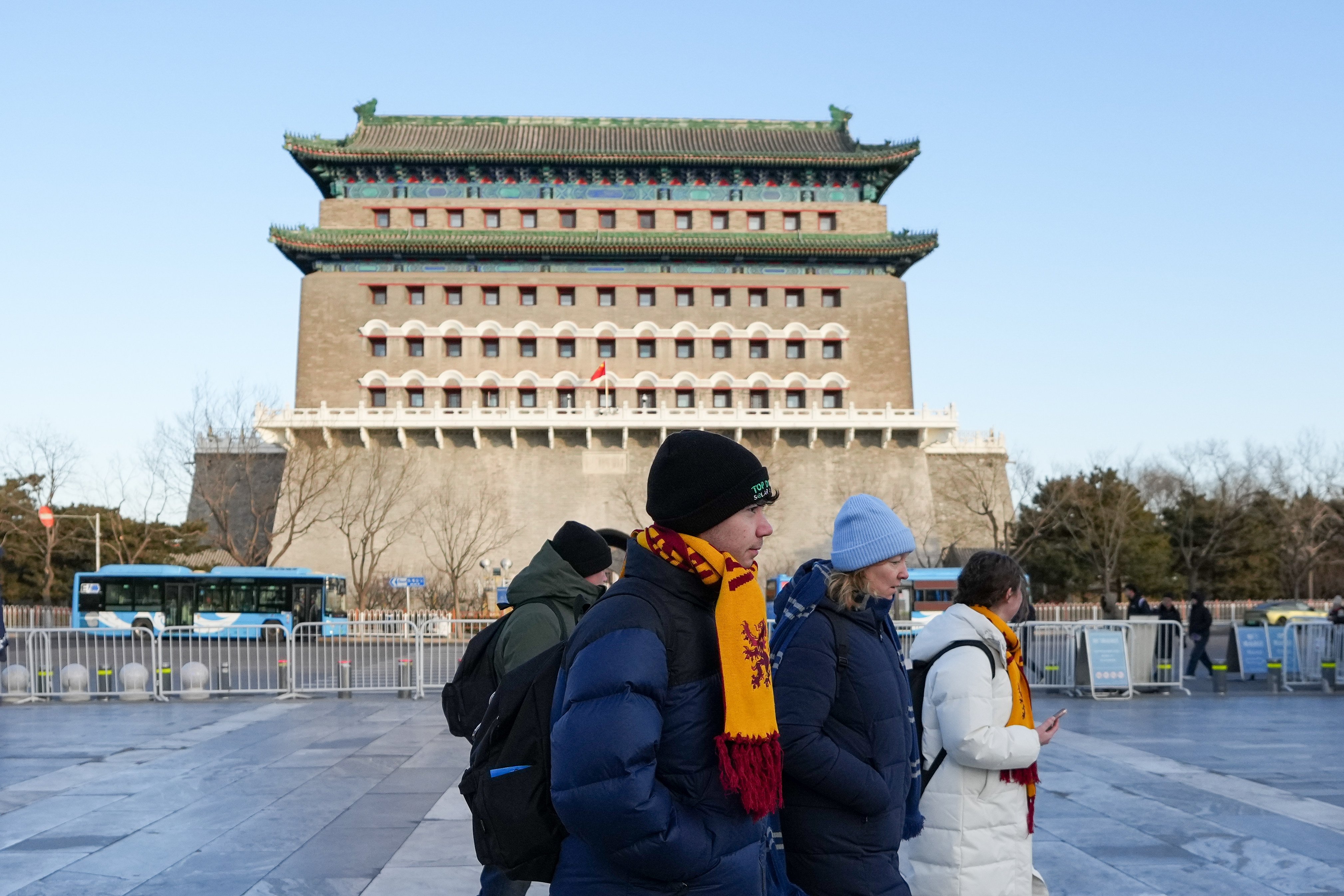 Foreign tourists visit Beijing’s Qianmen Street on December 26, days after China’s latest relaxation of visa rules. Photo: Xinhua