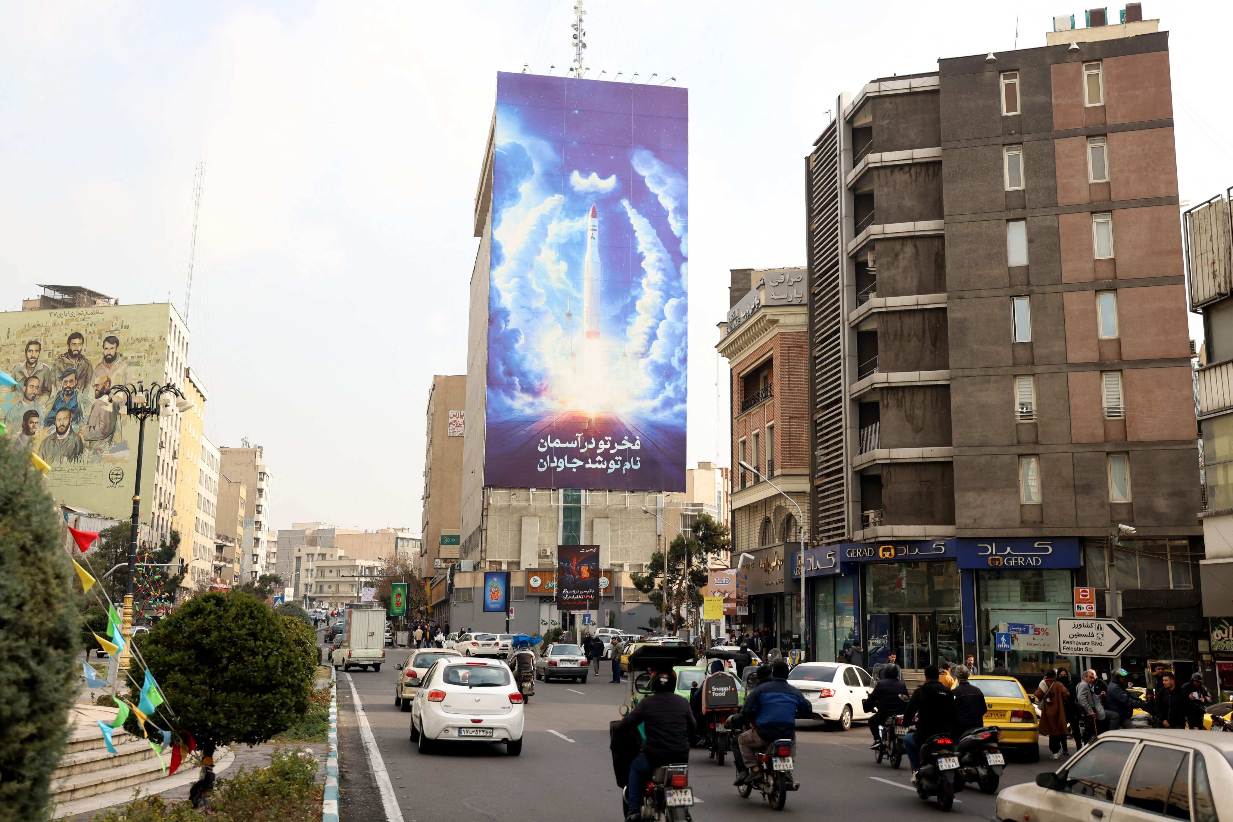 A billboard of a satellite rocket in Tehran. Iran denies any intention to develop atomic weapons. Photo: AFP