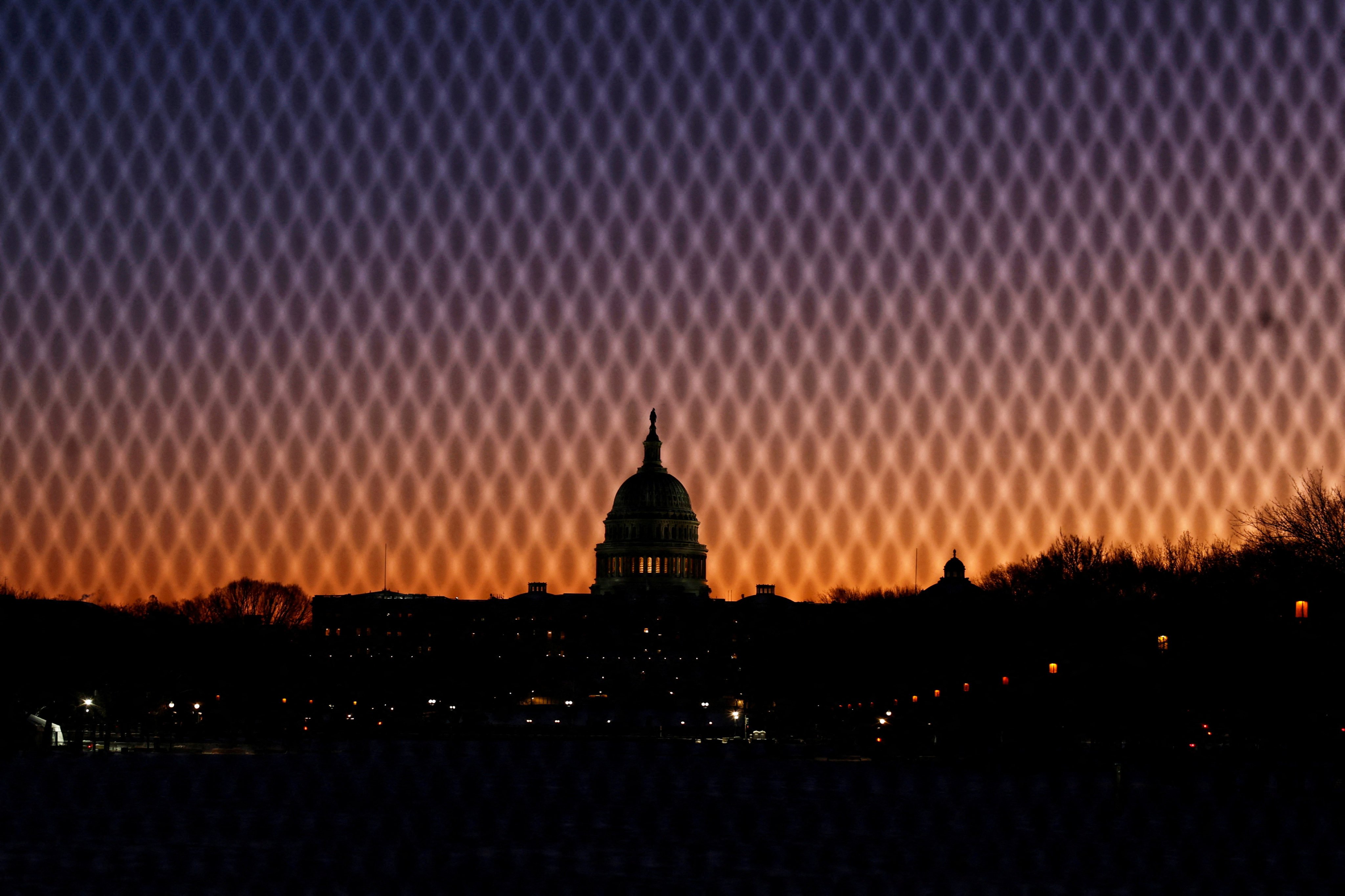 A security fence stands near the US. Capitol as the sun rises in Washington, on January 7. Photo: Reuters