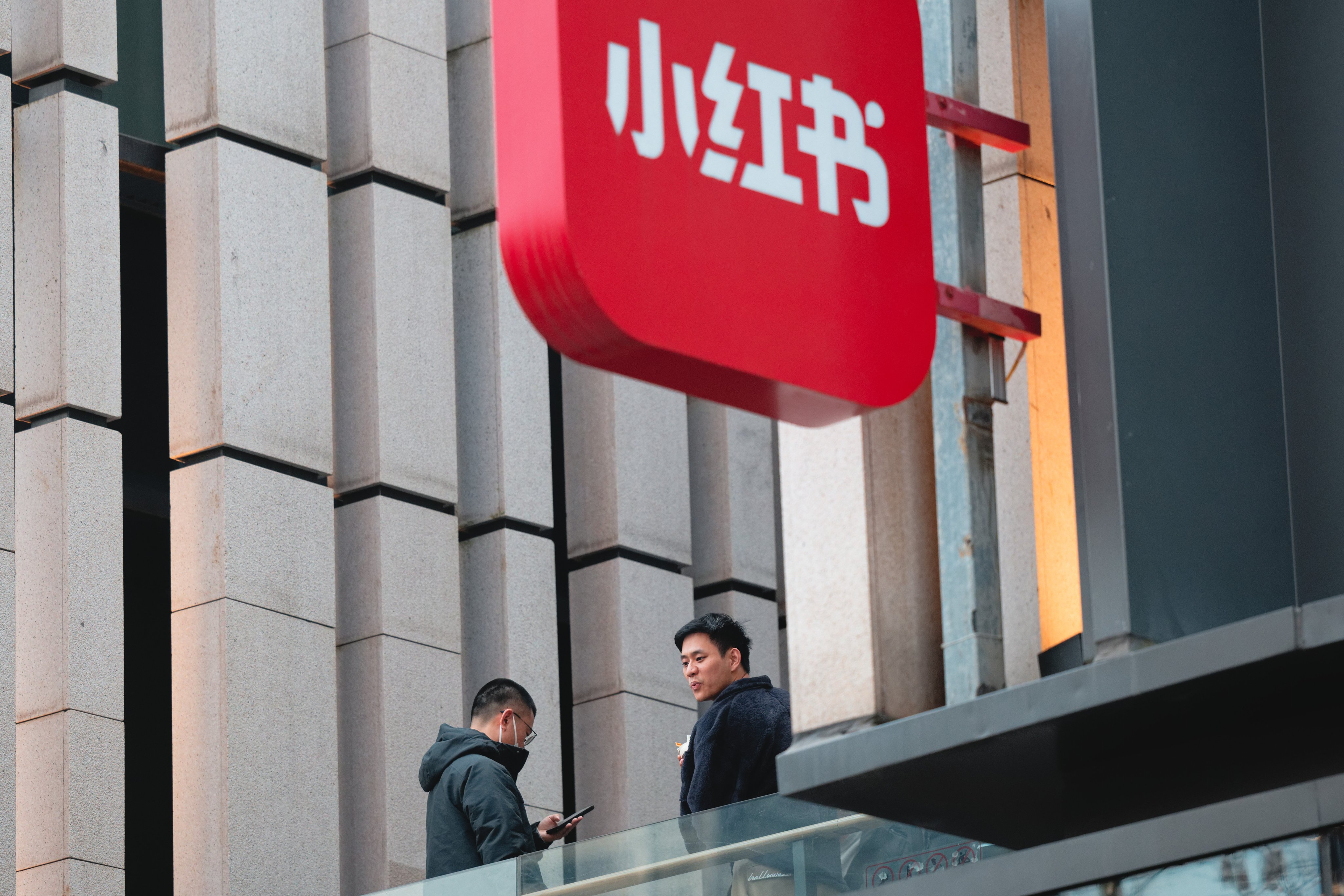 Employees on the balcony of the RedNote (also known as Xiaohongshu, meaning “little red book”) company headquarters building in Shanghai, China. The RedNote app has been seized on as an alternative to Tiktok, which faces a ban in the United States. Photo: EPA-EFE