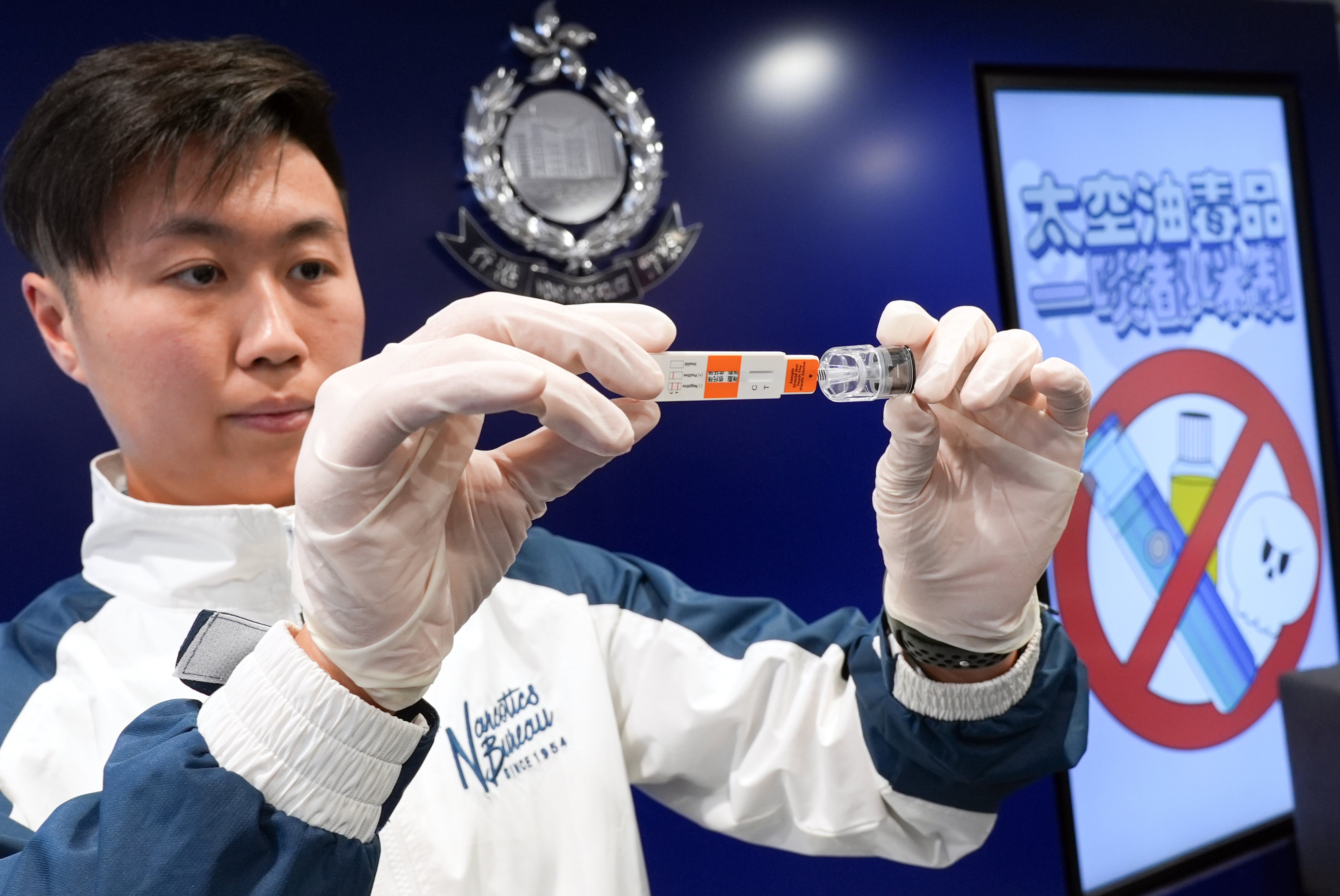 A police officer demonstrates the new rapid test kits. Photo: Eugene Lee