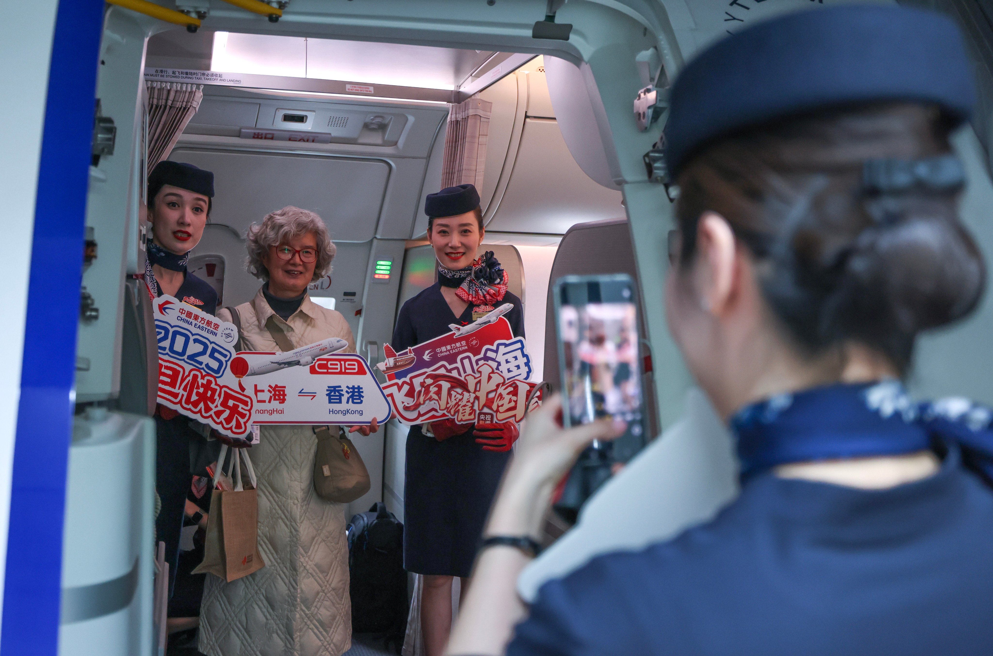 A passenger poses for a photo on China Eastern Airlines’ maiden C919 flight from Hong Kong to Shanghai on January 1. Photo: Nora Tam