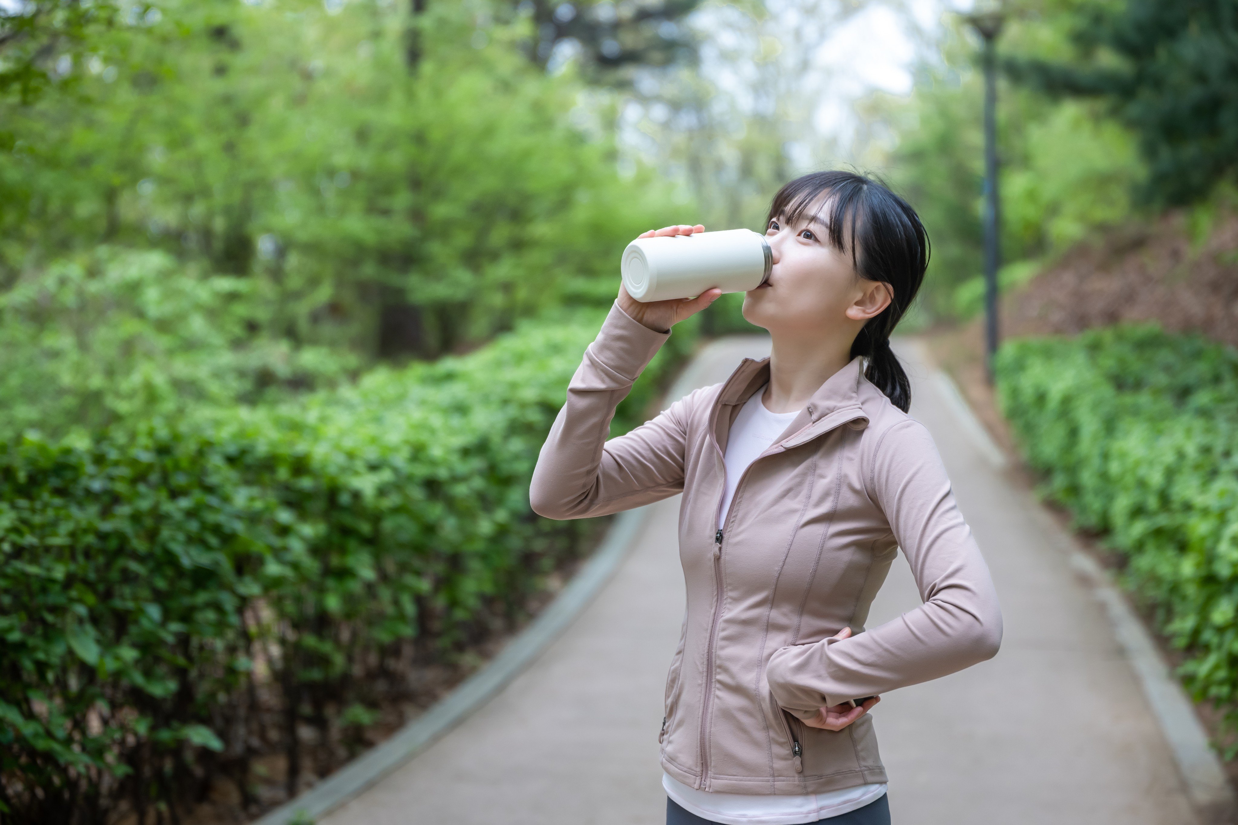 A woman drinking from a tumbler. Photo: Shutterstock