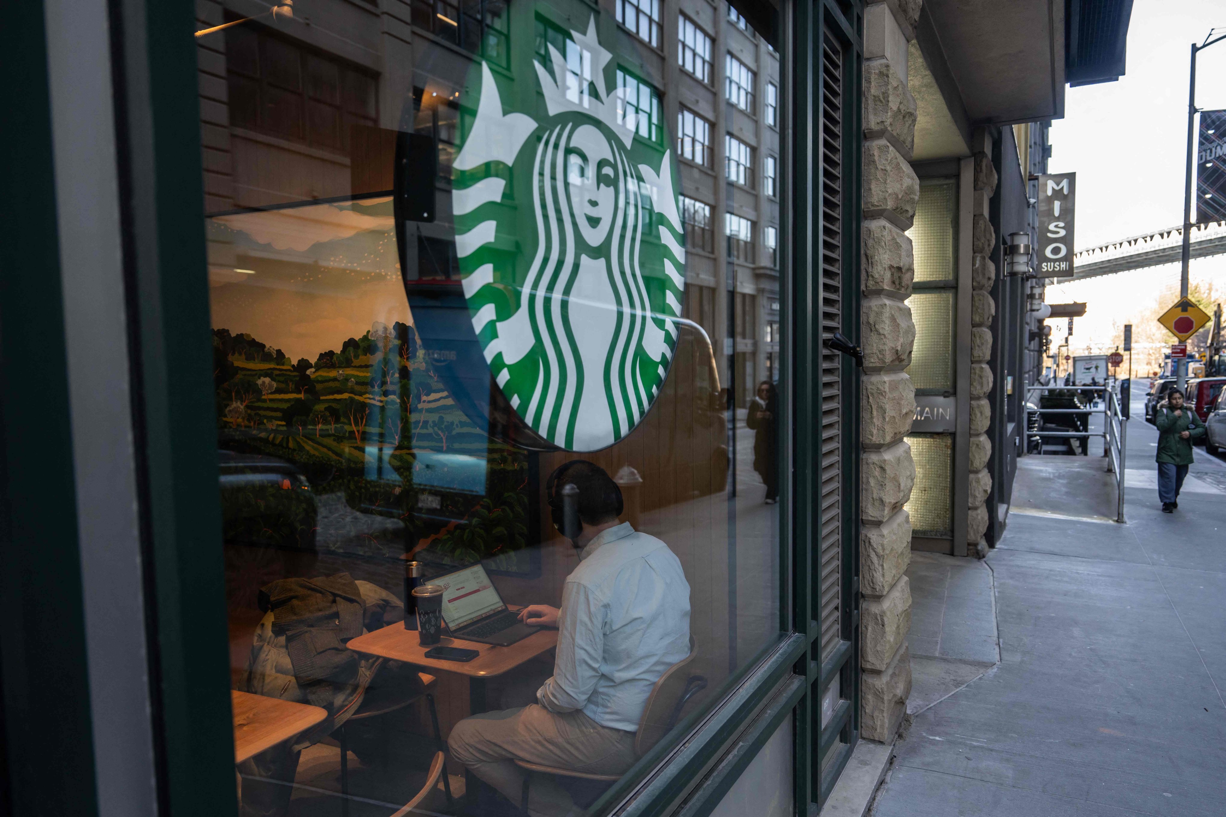 A person uses a laptop inside of a Starbucks in the Brooklyn Borough of New York City.  Photo: AFP