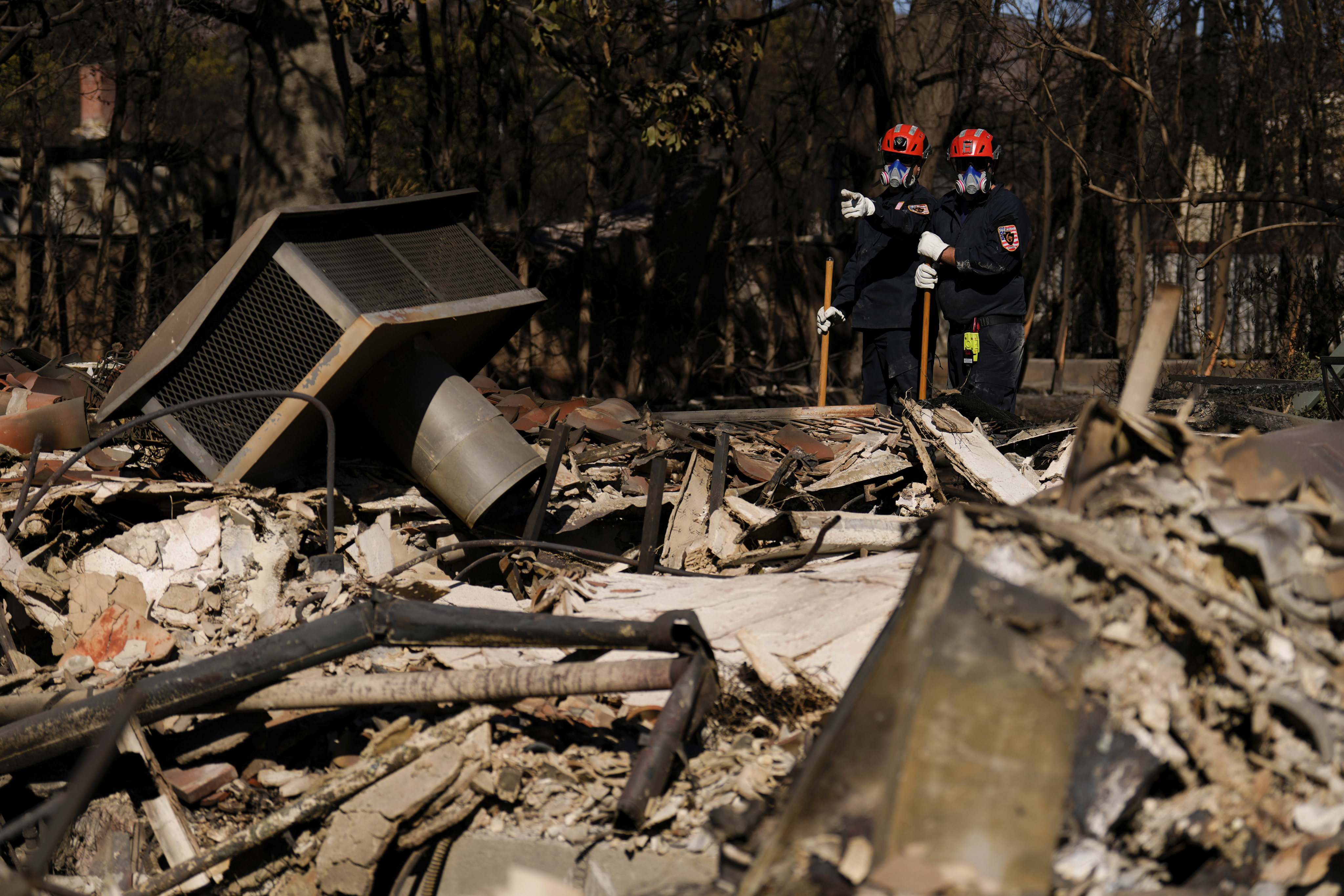 Members of a search and rescue crew among ruins in the Pacific Palisades neighbourhood of Los Angeles. Photo: AP