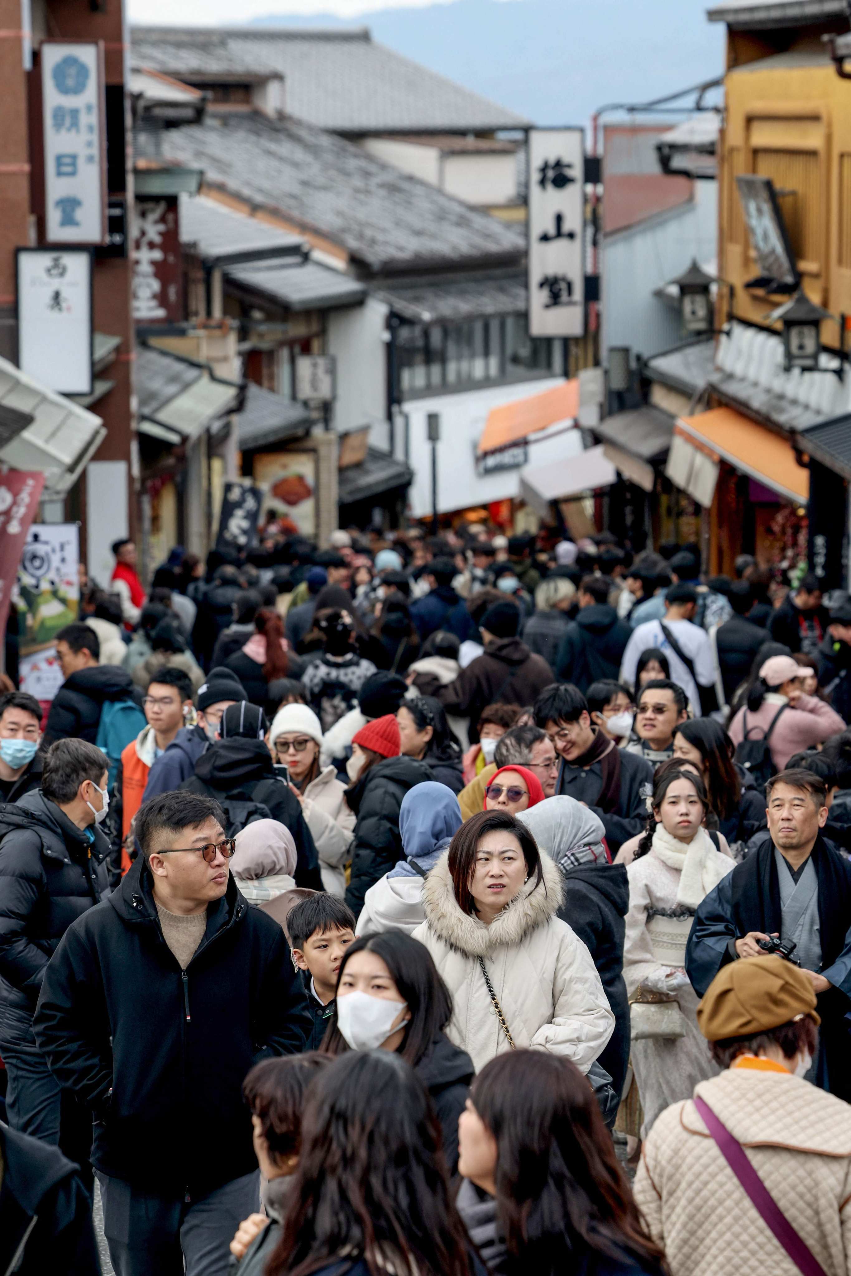 Tourists walk past shops and restaurants in Kyoto on Monday. Photo: AFP