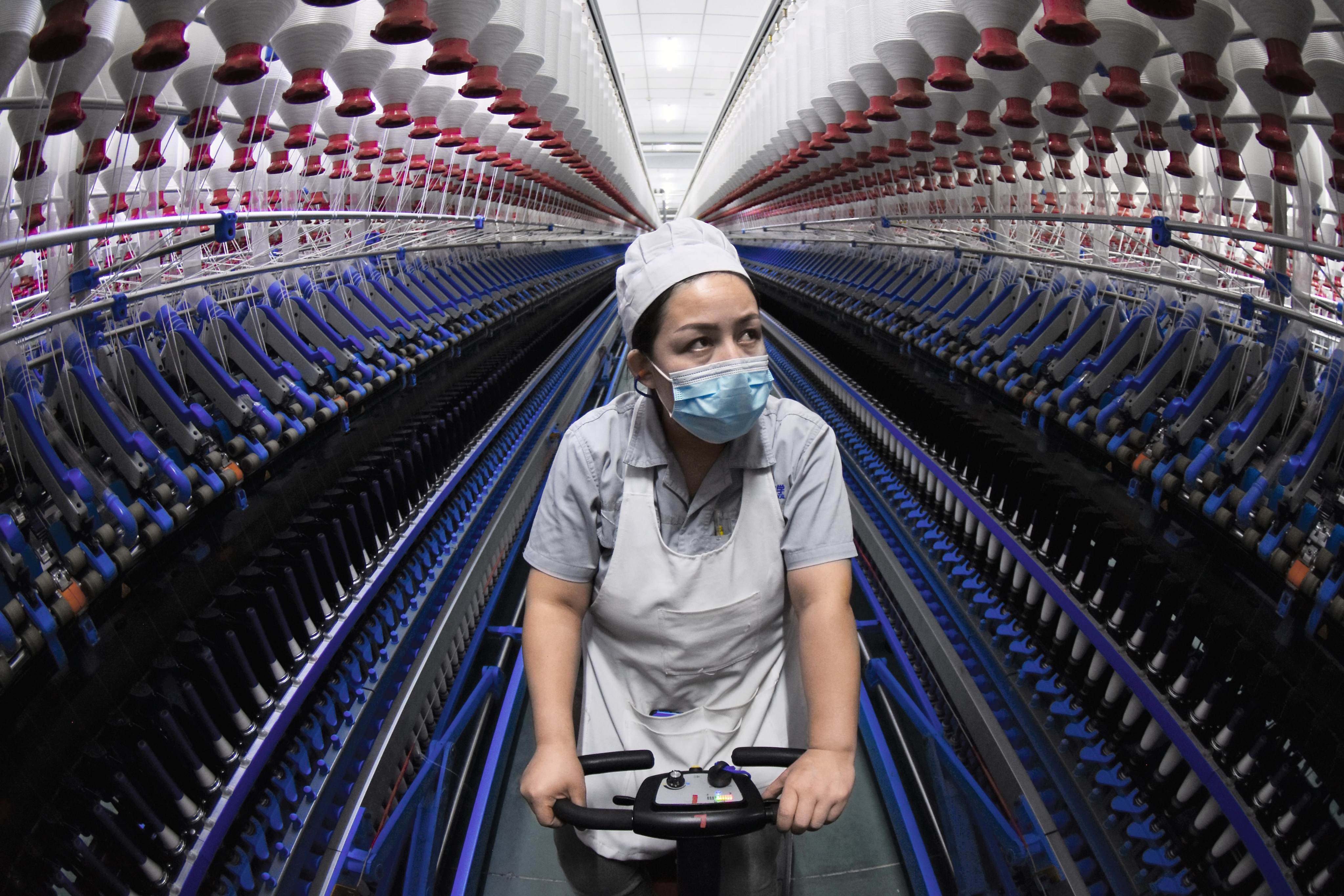 An employee works at a factory in China’s Xinjiang Uygur autonomous region. Xinjiang cotton has been in the global spotlight since 2020. Photo: Getty Images