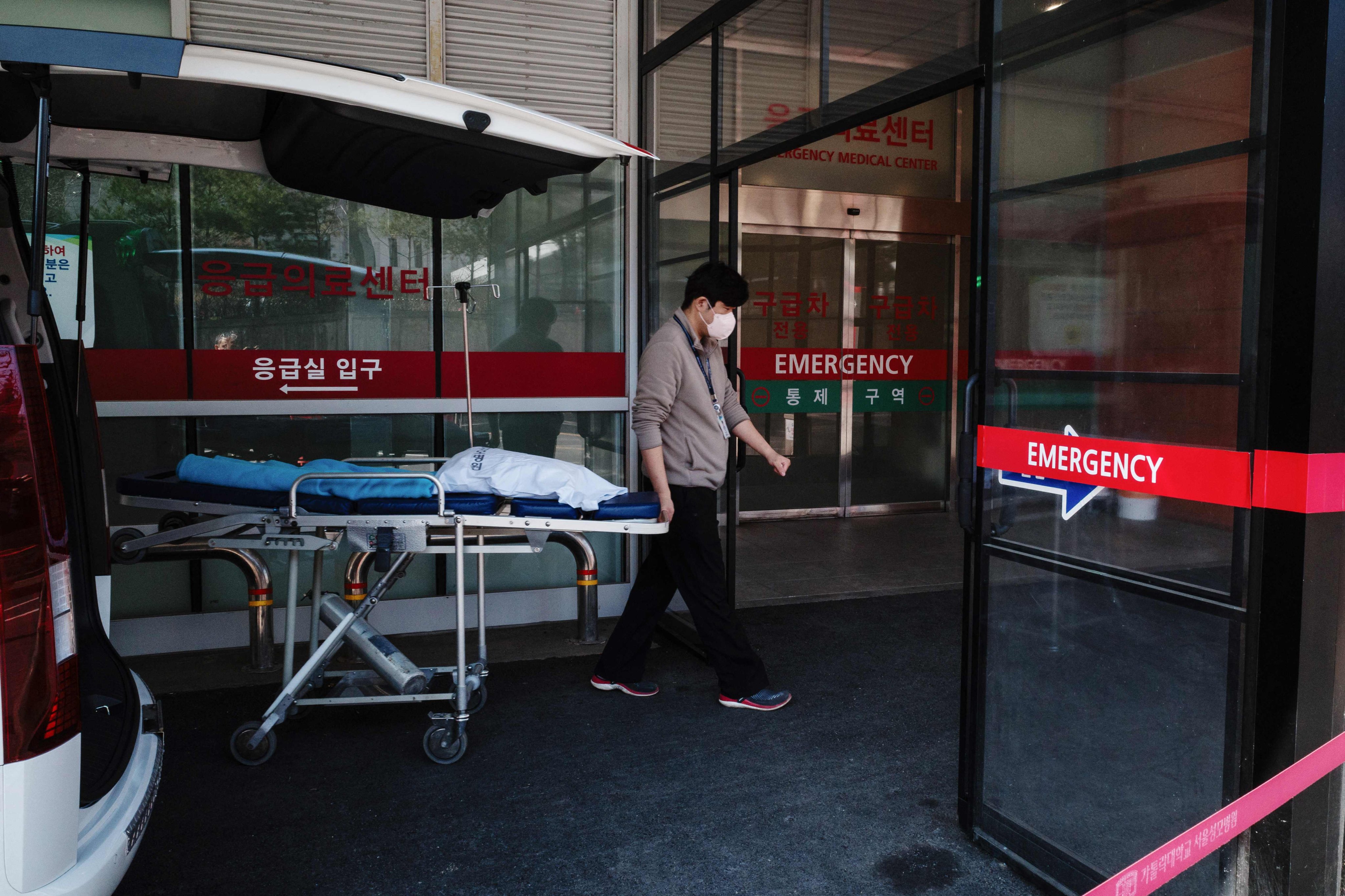 A medical worker rolls a stretcher into a hospital in Seoul. Photo: AFP