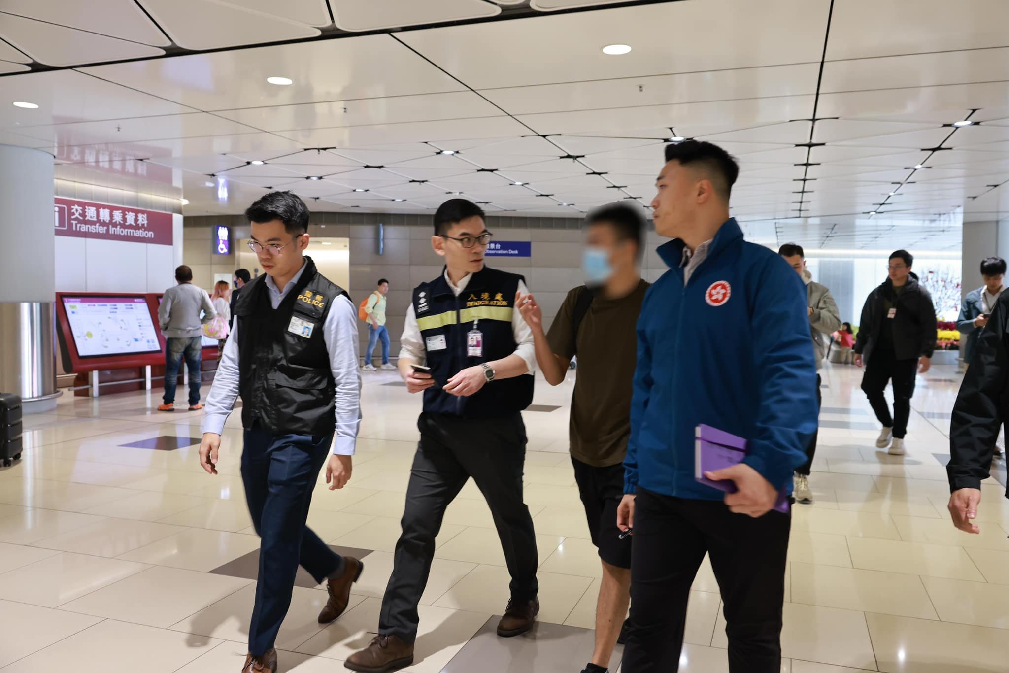 The victim is received by members of the Security Bureau, police and the Immigration Department at Hong Kong airport. Photo: Security Bureau