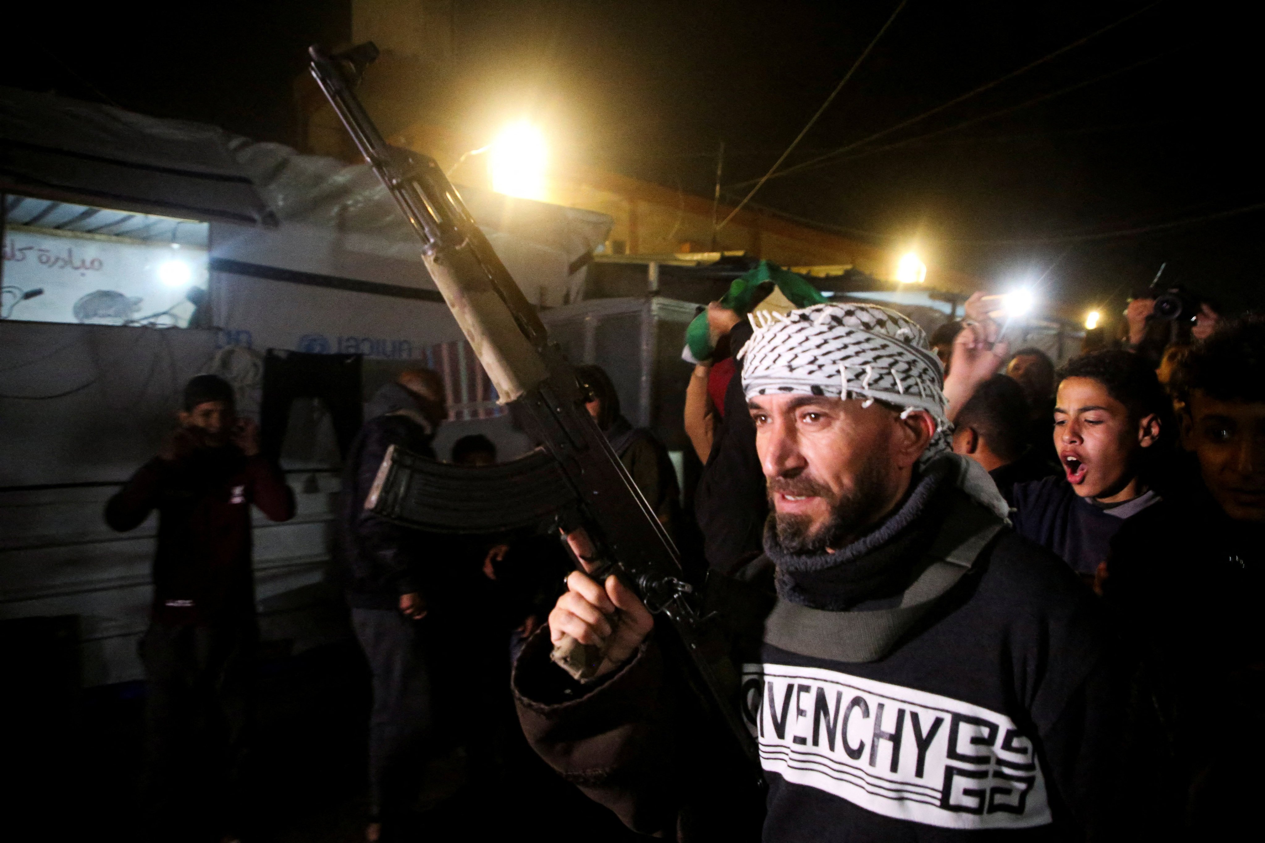 A gunman holds a weapon as Palestinians react to news of the ceasefire, in Khan Younis in the southern Gaza Strip. Photo: Reuters