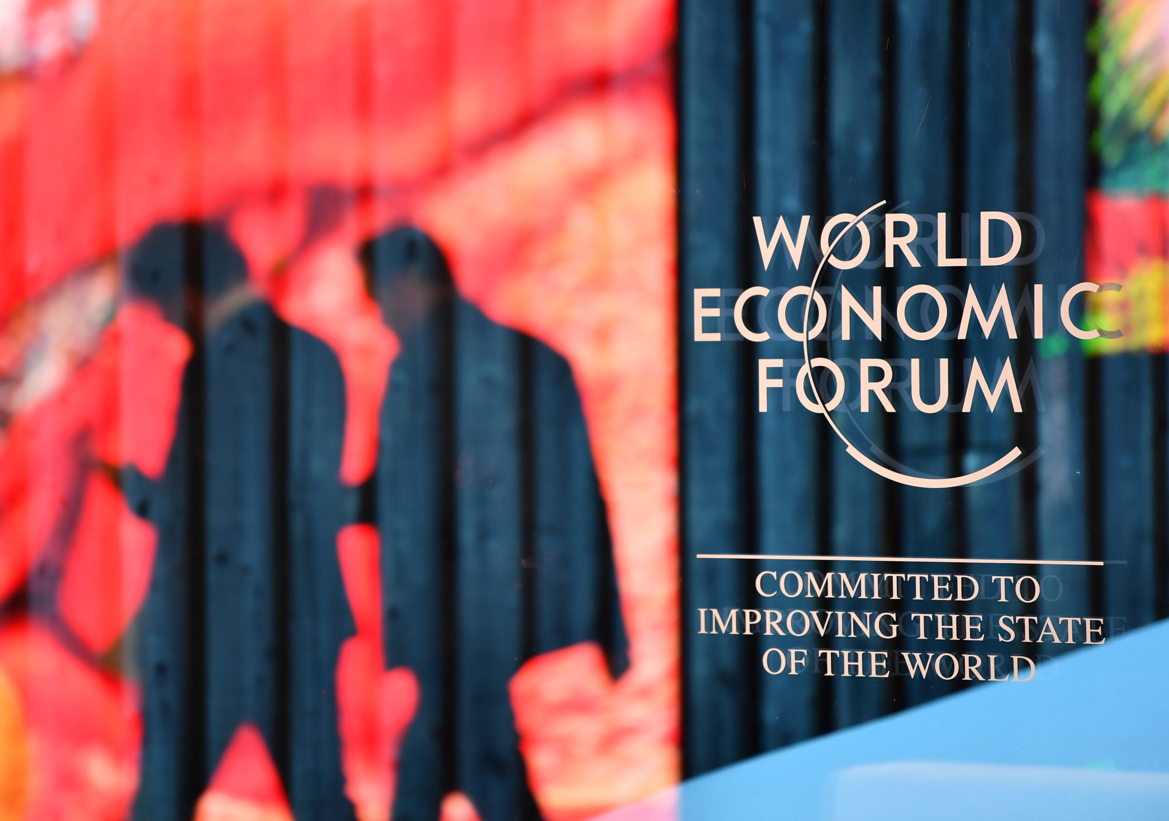 People walk past the logo of the World Economic Forum in Davos, Switzerland, on January 14, 2024. Photo: Xinhua