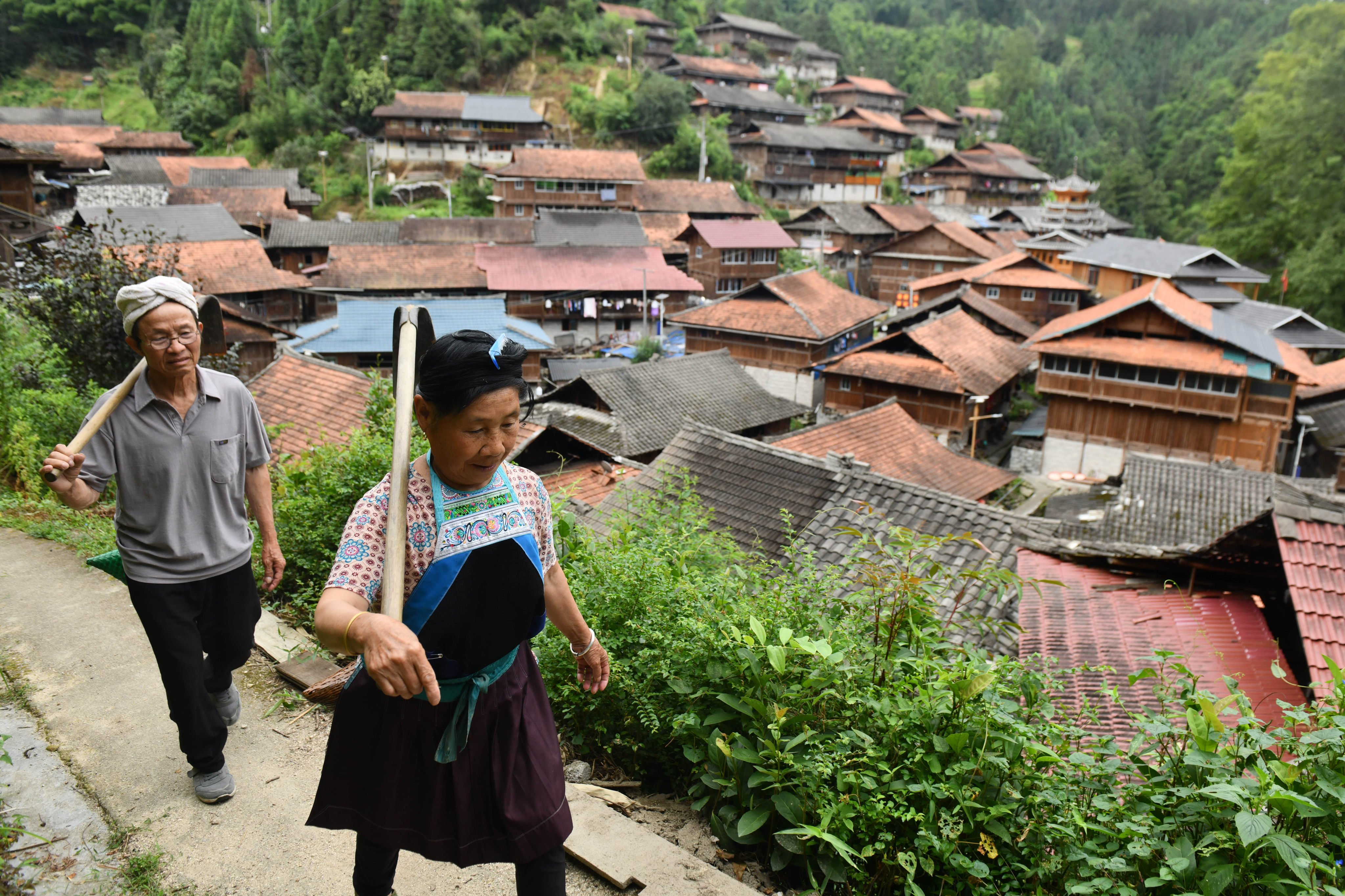 A couple walks in Wuying Village on the border between south China’s Guangxi Zhuang Autonomous Region and southwest China’s Guizhou Province, on July 18, 2024. Photo: Xinhua