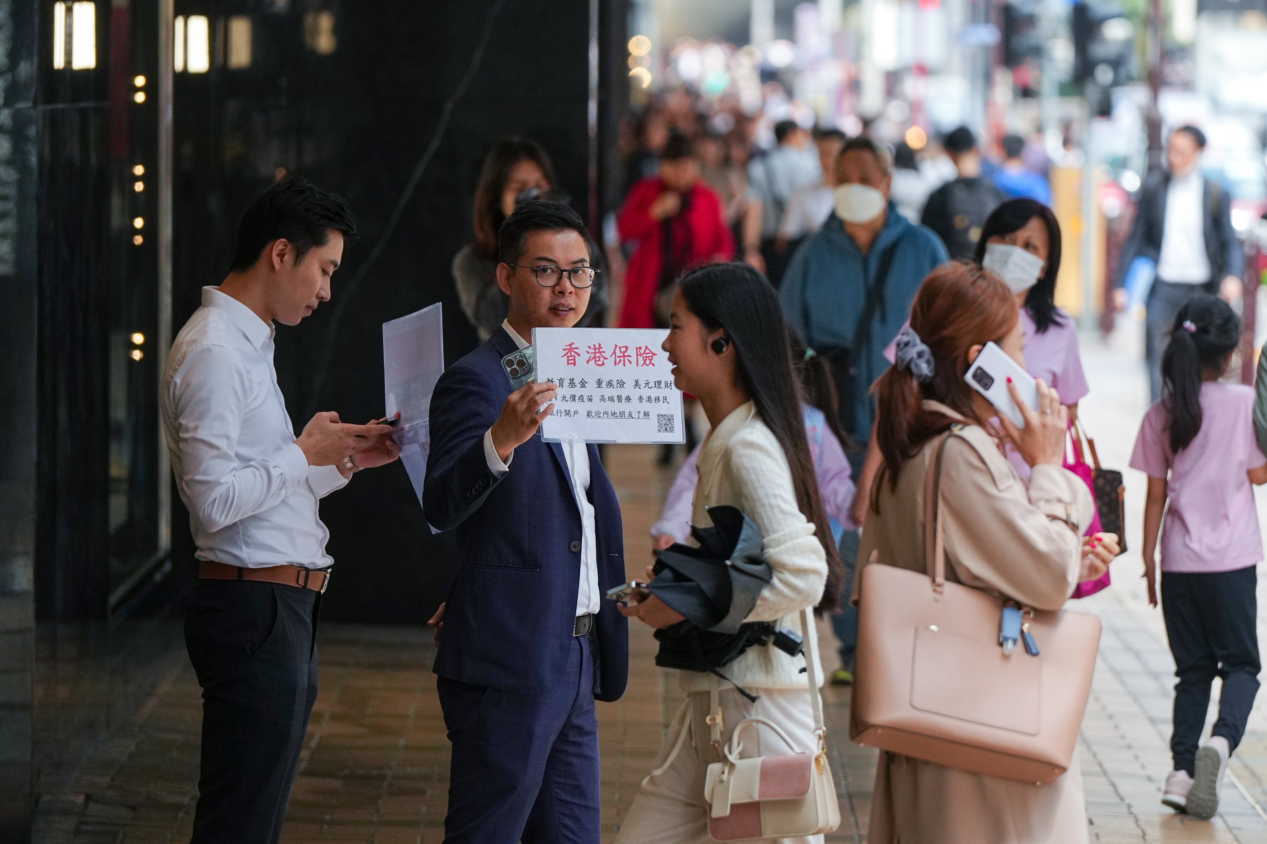 Insurance sales agents approach mainland tourists in Canton Road, Tsim Sha Tsui on 20 February 2024. Photo: Eugene Lee