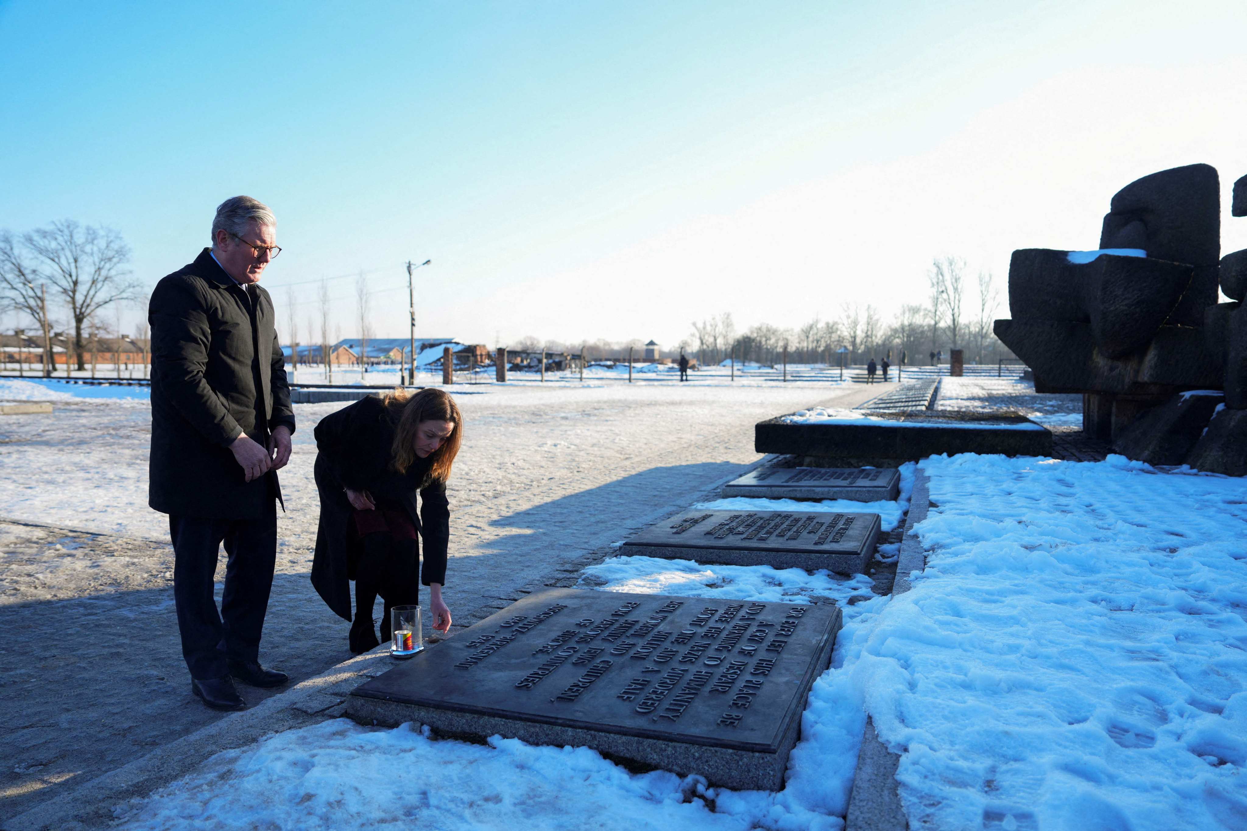 British Prime Minister Keir Starmer and his wife Victoria place a candle and a stone from Downing Street at a memorial monument during their visit to the Memorial And Museum Auschwitz-Birkenau. Photo: AFP