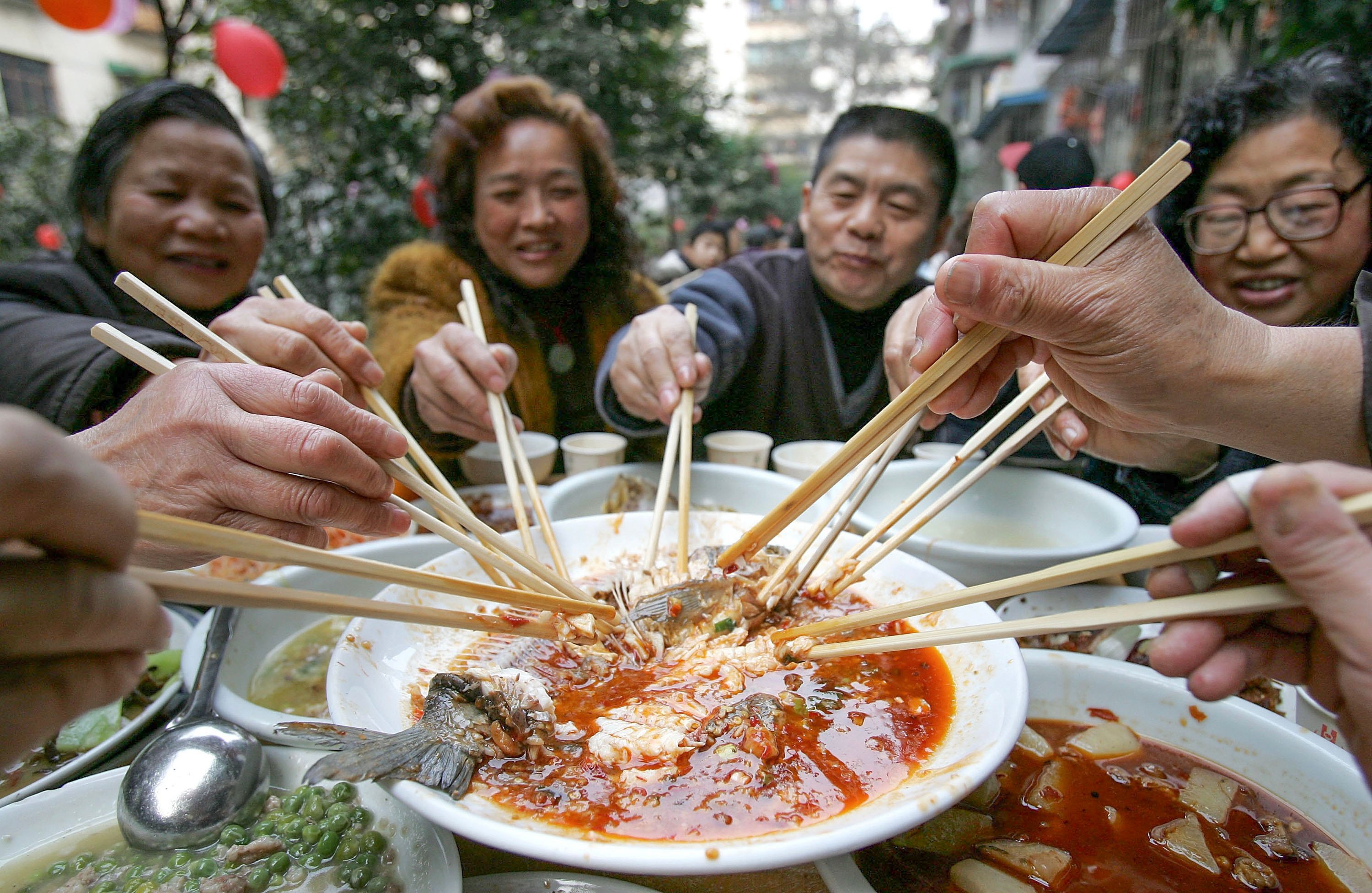 People in Chengdu, southwest China, enjoy a Lunar New Year feast. There are auspicious foods to eat during the festival, and others you should avoid if you want good fortune in the new lunar year. Photo: Getty Images