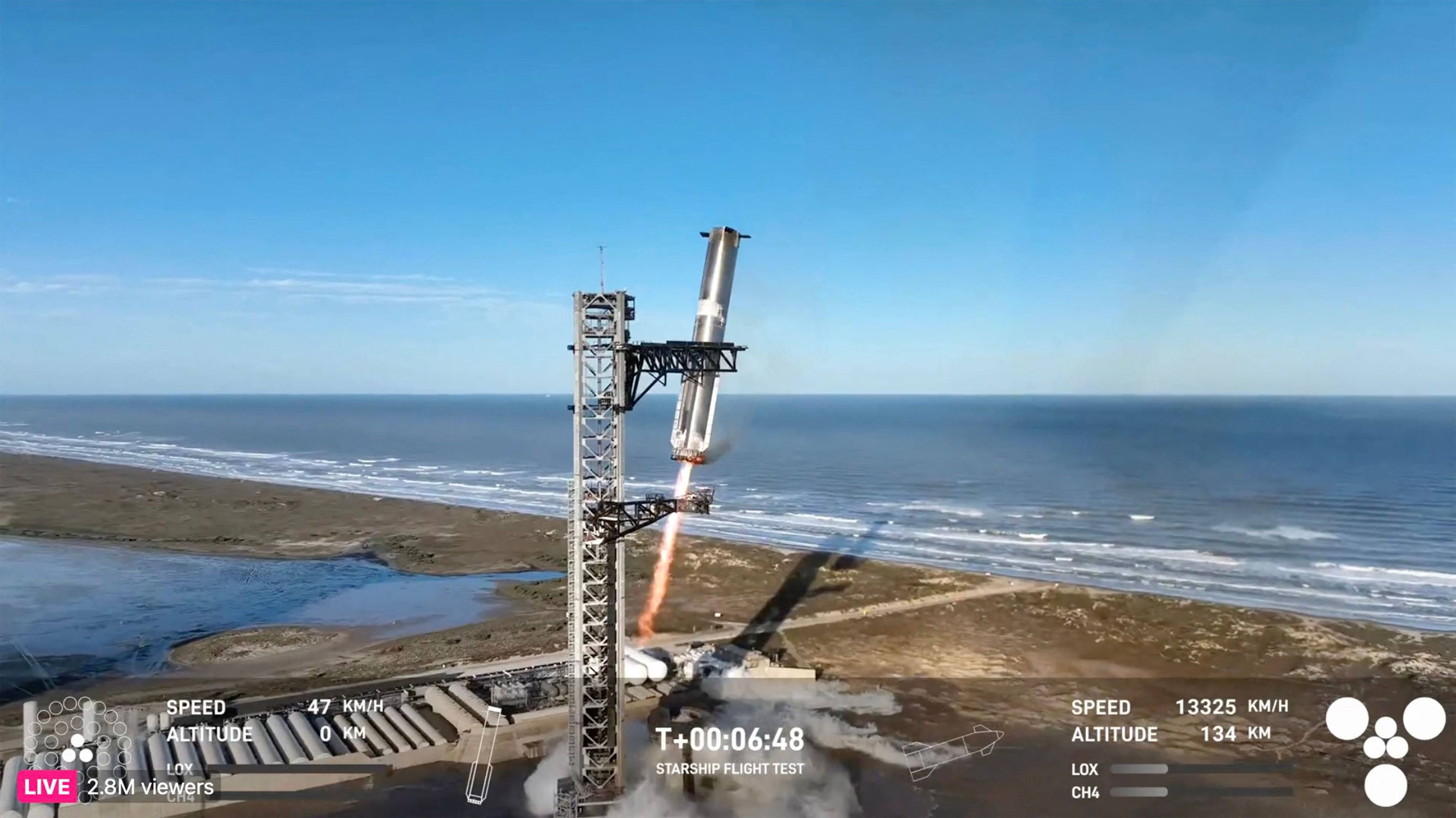 The Starship’s Super Heavy Booster being grappled mid-air as it returns to the launch pad at Starbase near Boca Chica, Texas. Photo: SpaceX via AFP