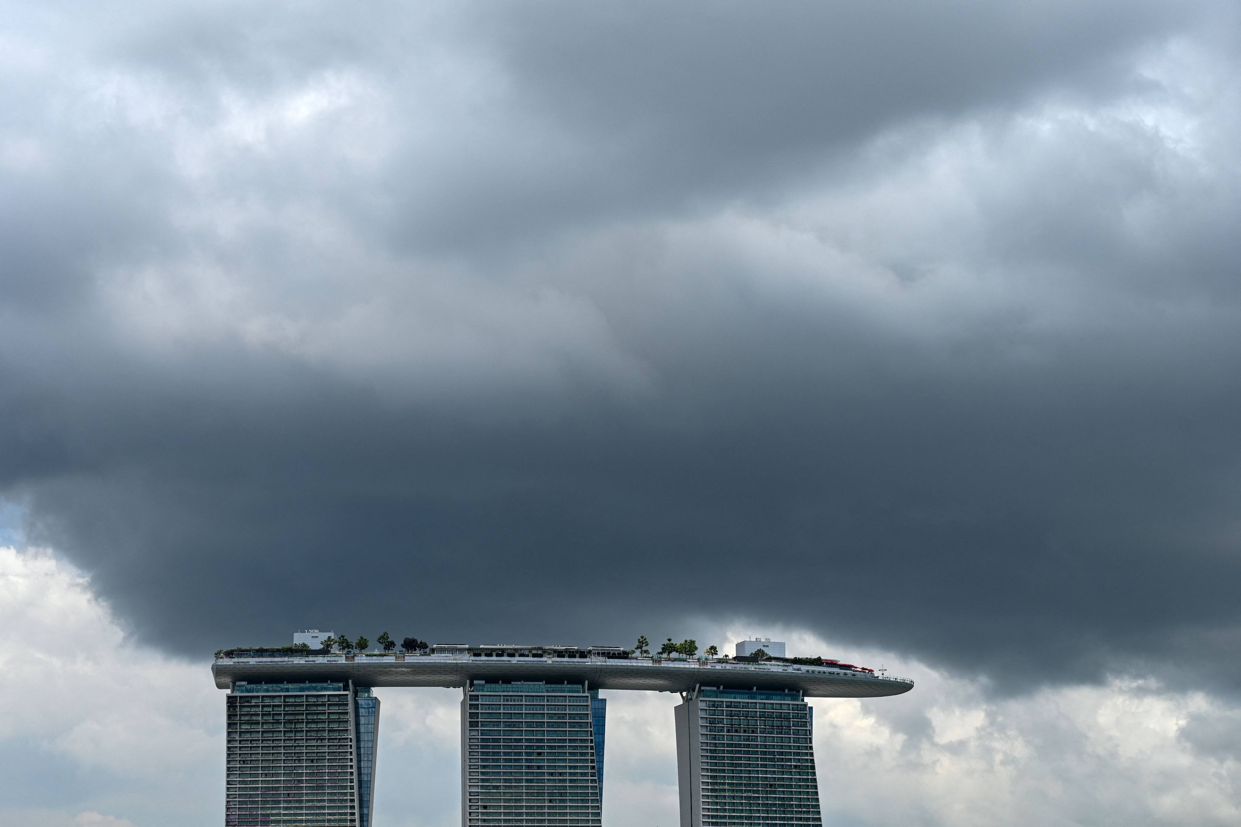 Rain clouds hover above the Marina Bay Sands hotels in Singapore. Photo: AFP