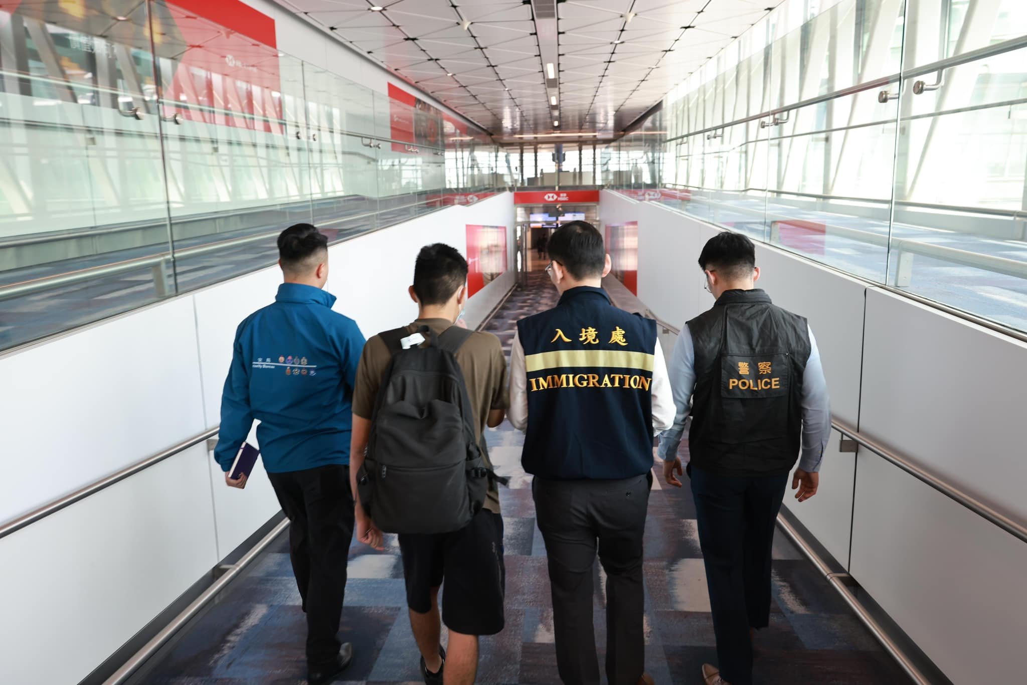 A recently freed job scam victim is received by members of the Security Bureau, police and the Immigration Department at Hong Kong’s airport. Photo: Security Bureau