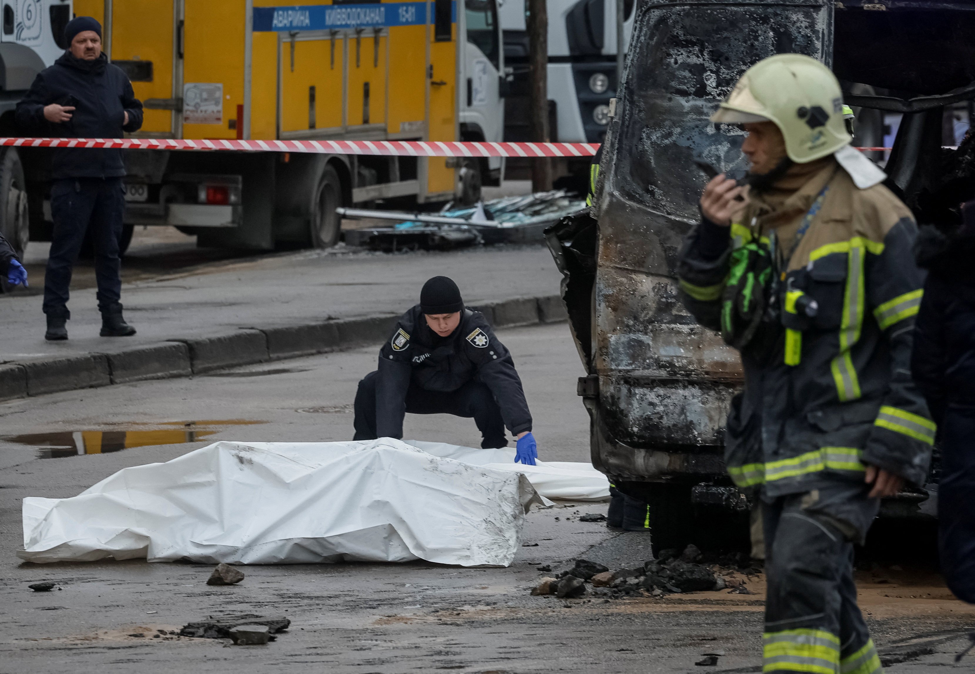 A police officer closes a bag with the body of a person killed by Russian missile strikes, amid Russia’s attack on Ukraine, in Kyiv, Ukraine, on Saturday. Photo: Reuters