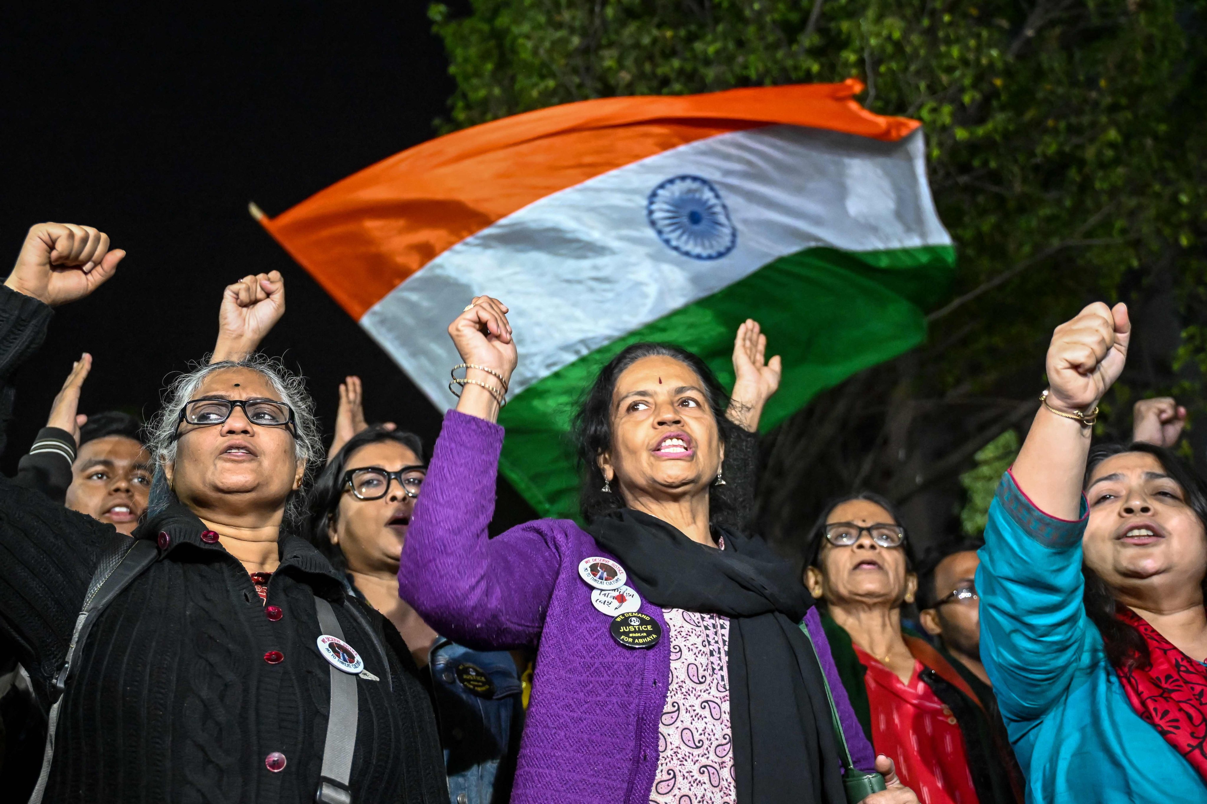 Doctors and social activists shout slogans as they protest to condemn the rape and murder of a doctor, in Kolkata, on Friday. Photo: AFP