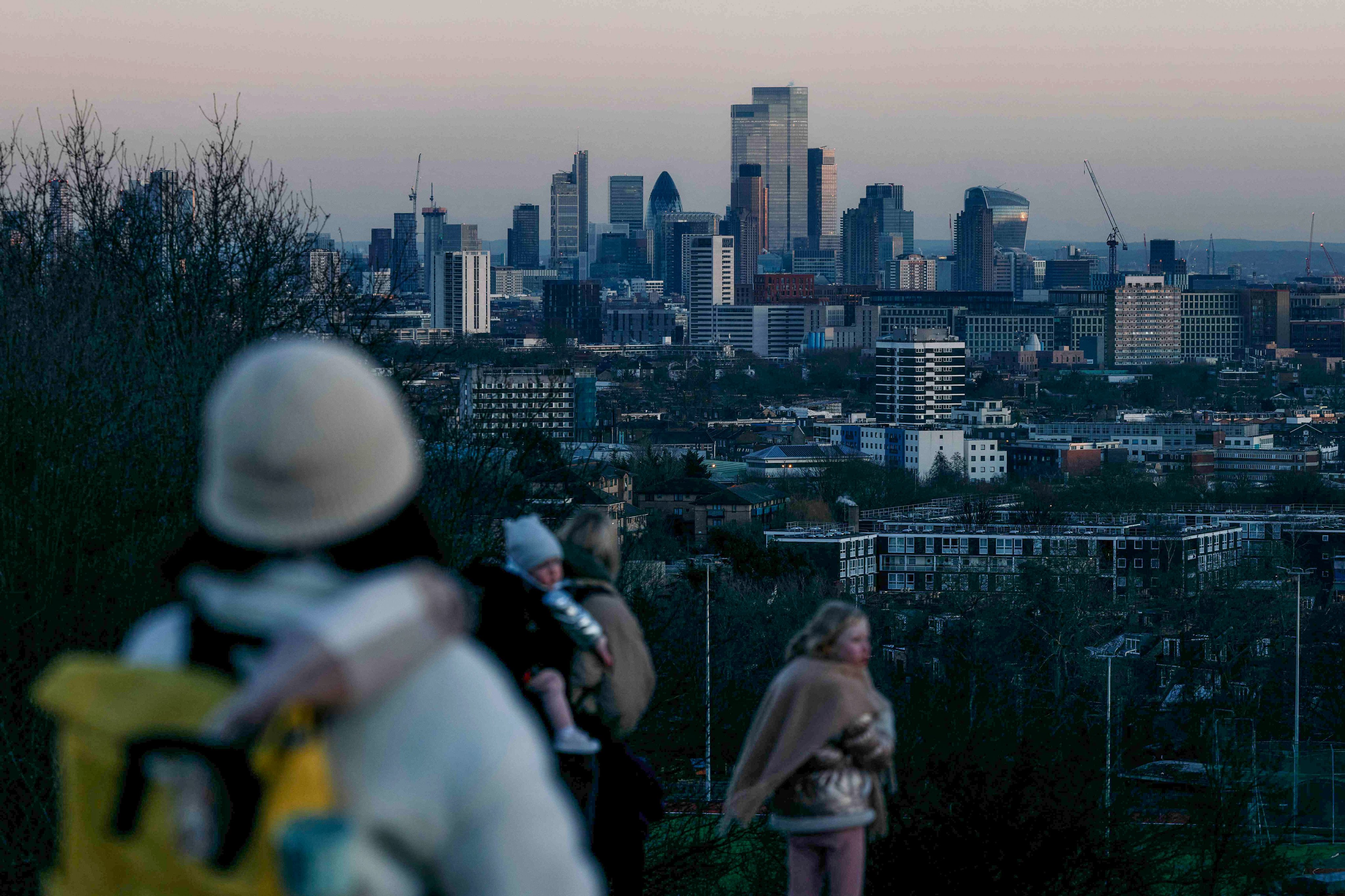 People view the office buildings of the City of London from Parliament Hill in the Hampstead suburb of north London. Photo: AFP 