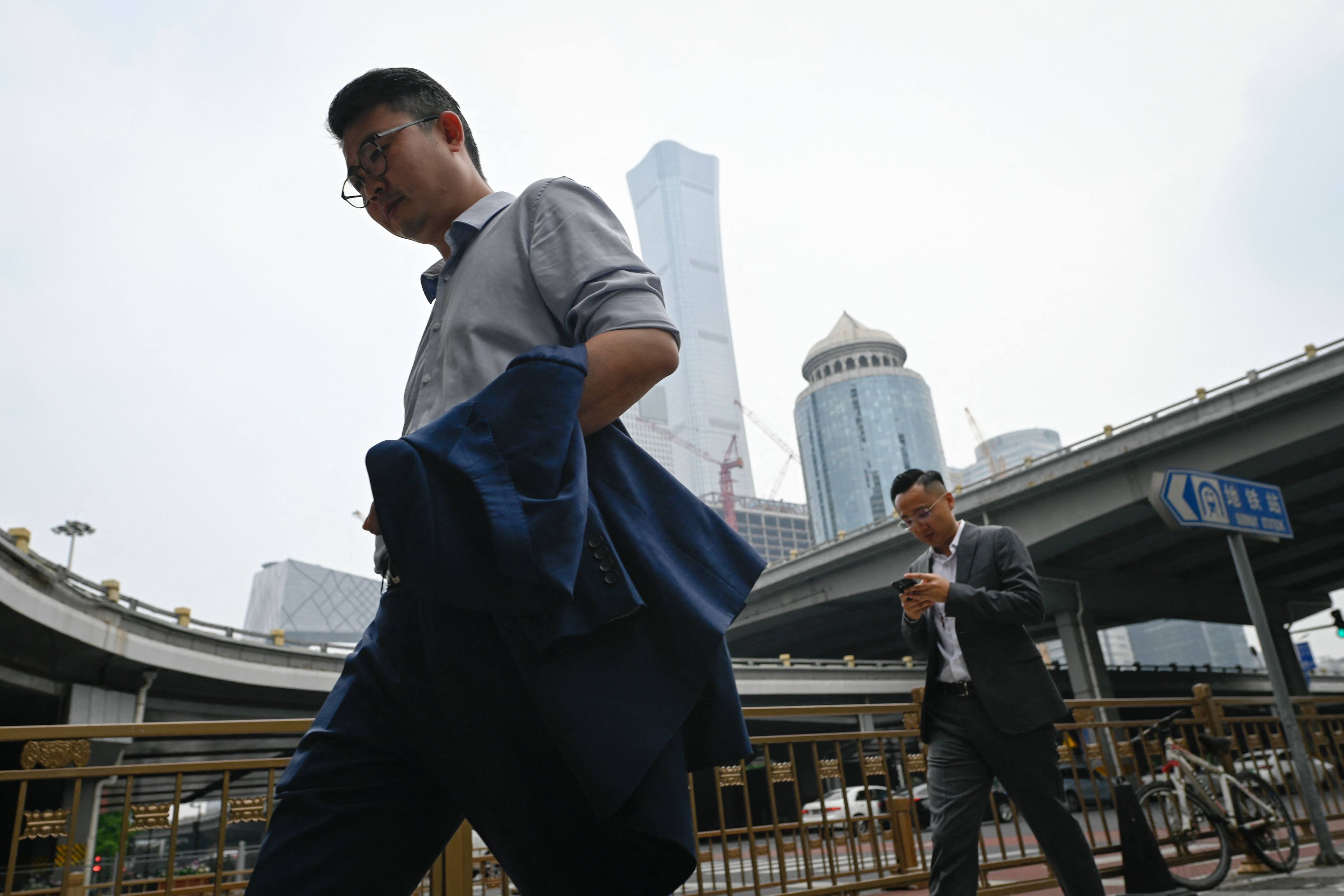 People passed through Beijing’s central business district. Photo: AFP