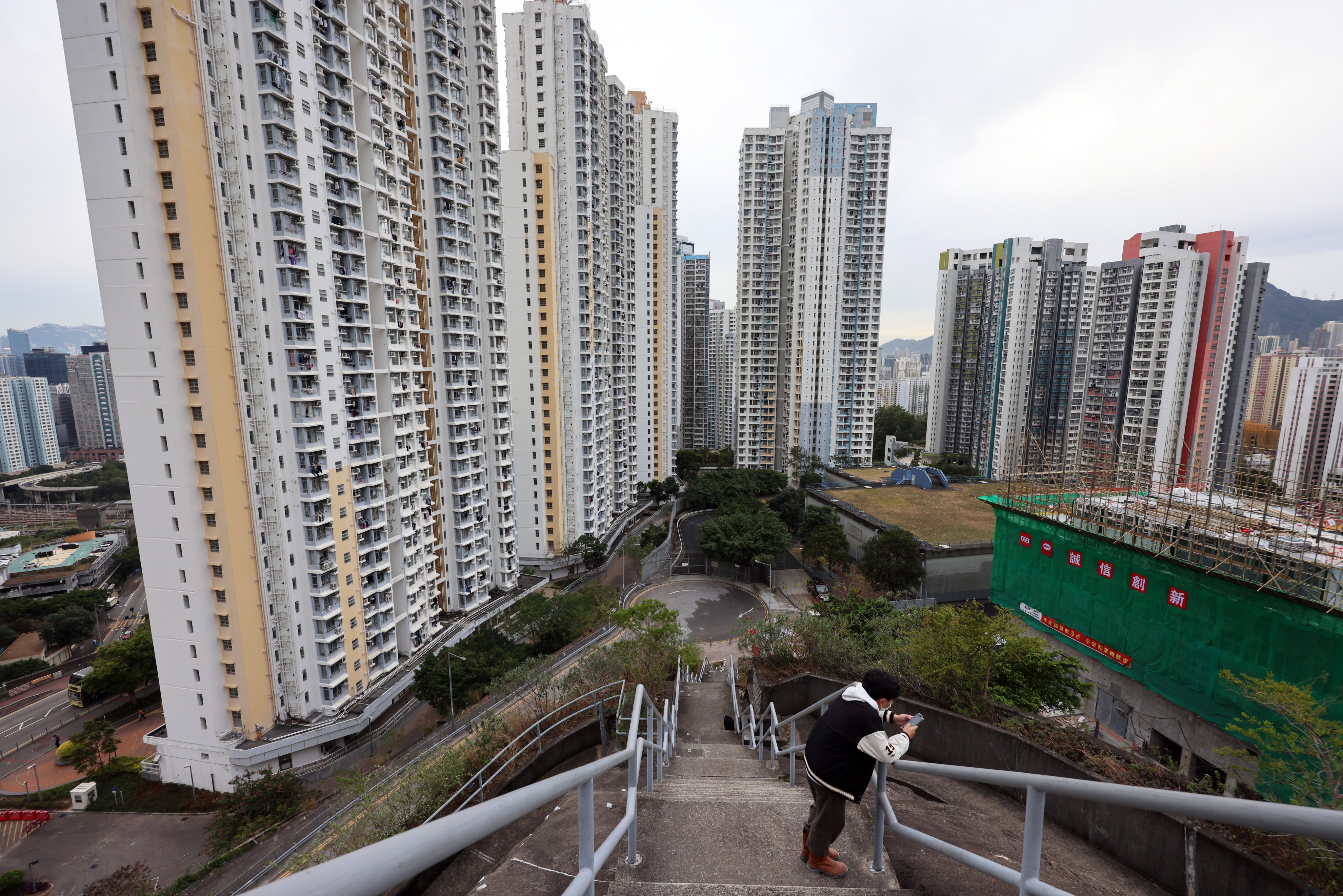 A pedestrian checks his phone near a public housing estate at Ngau Tau Kok on January 15. Photo: Jelly Tse