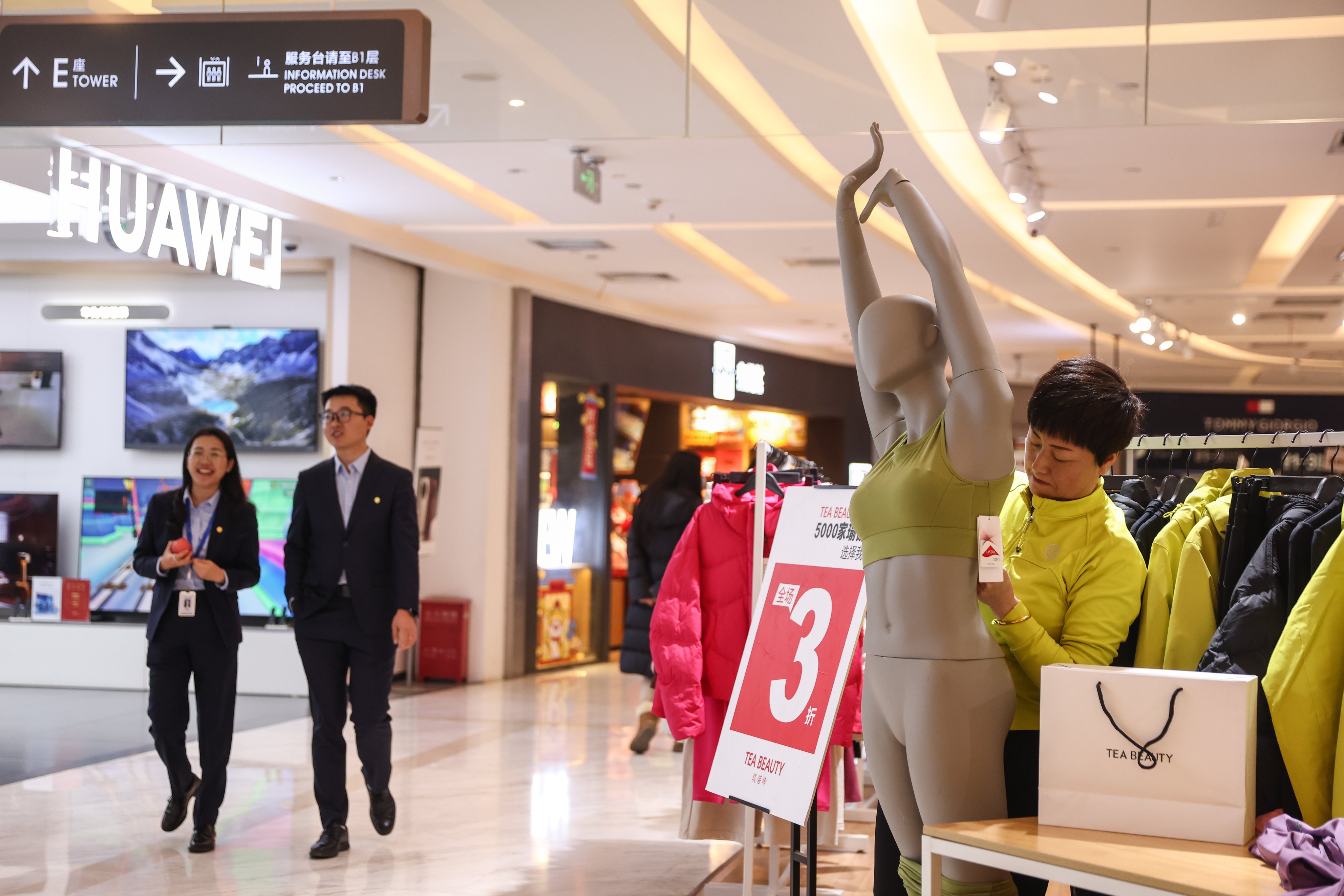 A sales clerk works at a clothing store in a shopping mall in Beijing on January 13, 2025. Photo: EPA-EFE