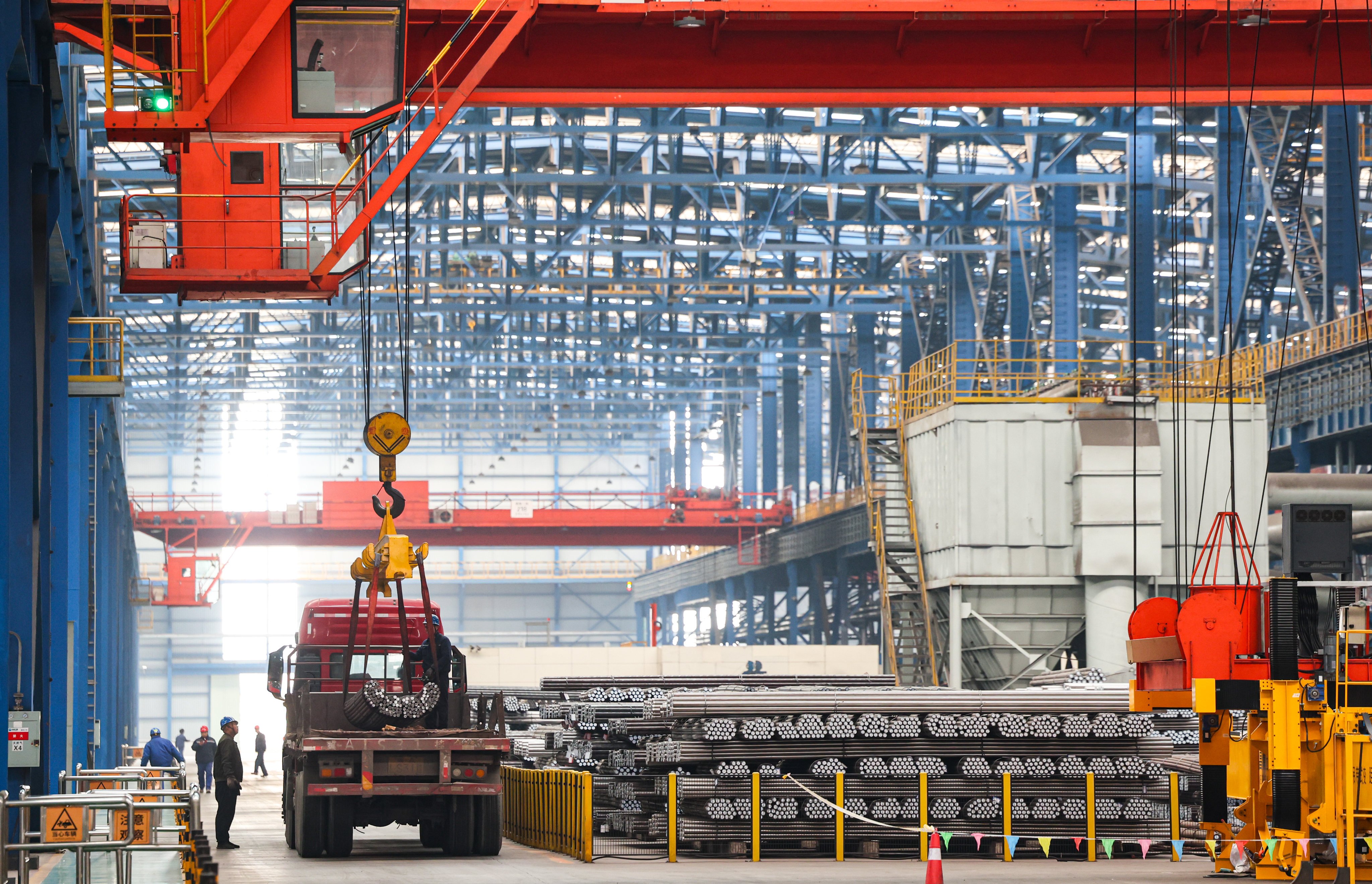 Workers at HBIS Group Shijiazhuang Iron and Steel hoist steel for transport in northern Hebei province in January 2025. Photo: Xinhua