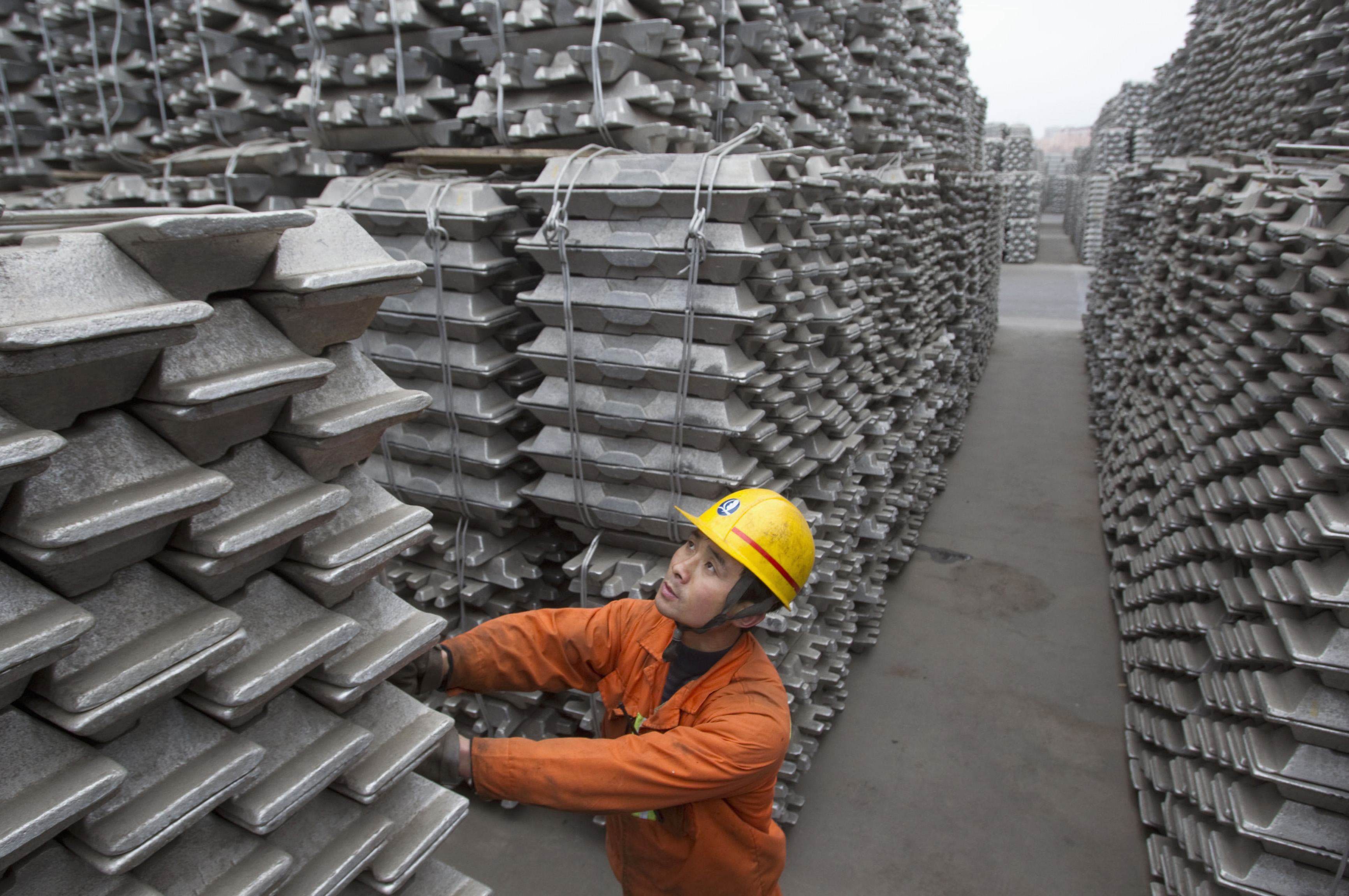 An employee checks aluminium ingots for export at Qingdao Port, Shandong province, in this March 14, 2010 file photo. Photo: Reuters