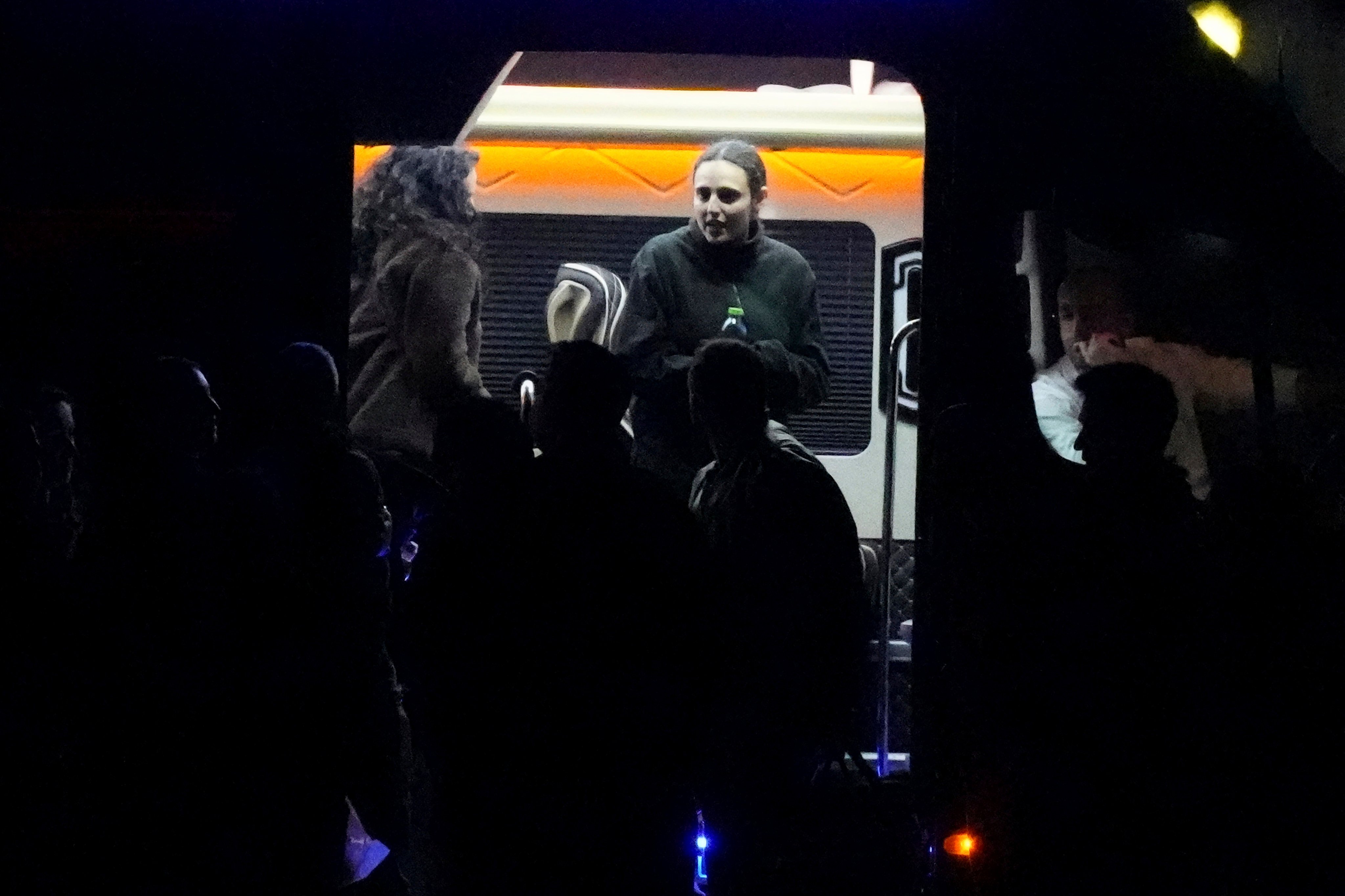 Romi Gonen steps out of a van next to her mother Merav, left, before boarding a helicopter. Photo: AP