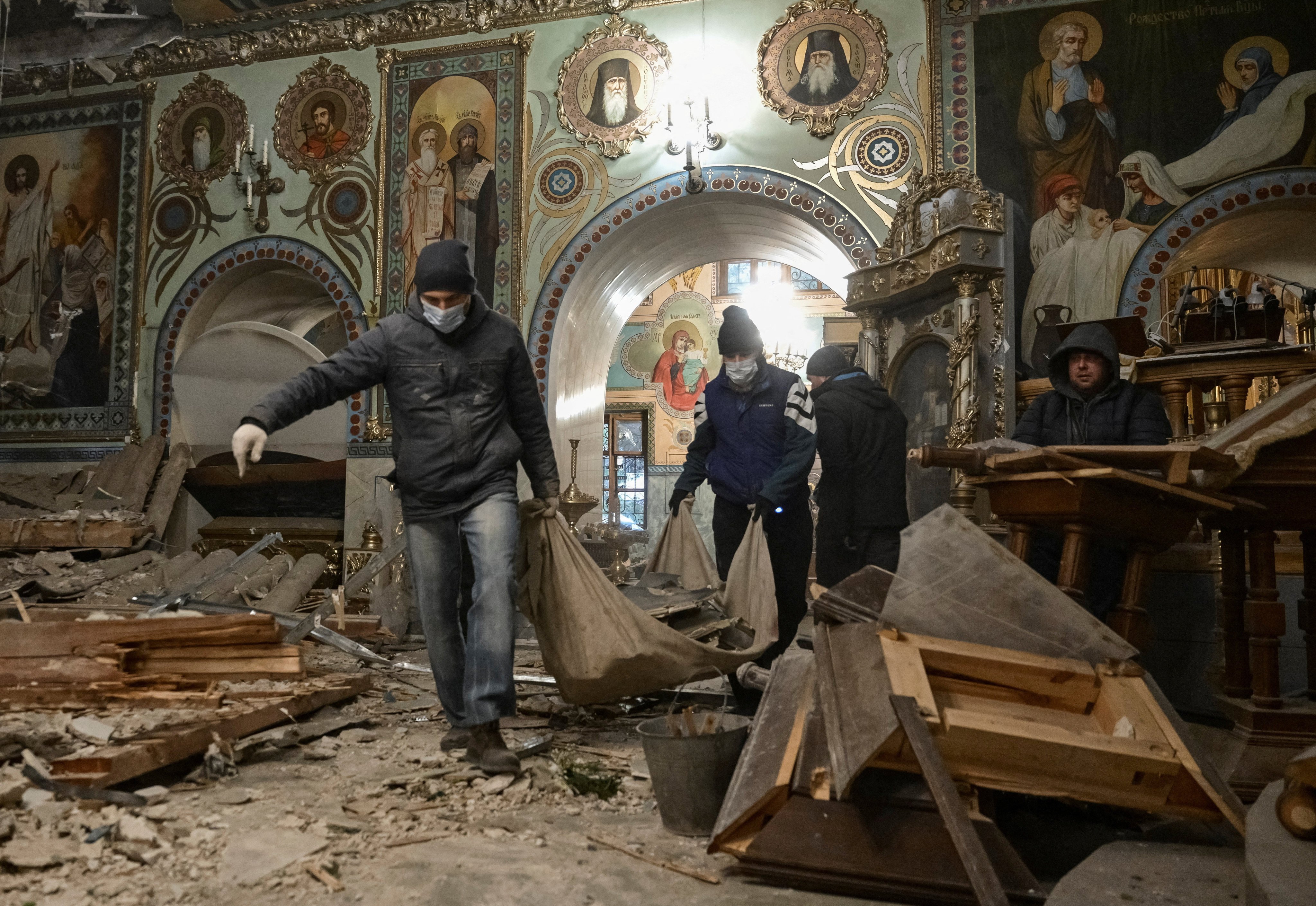 Priests and worshippers clear debris inside St Andrew’s Cathedral damaged by Russian missile strikes, in Zaporizhzhia, Ukraine. Photo: Reuters