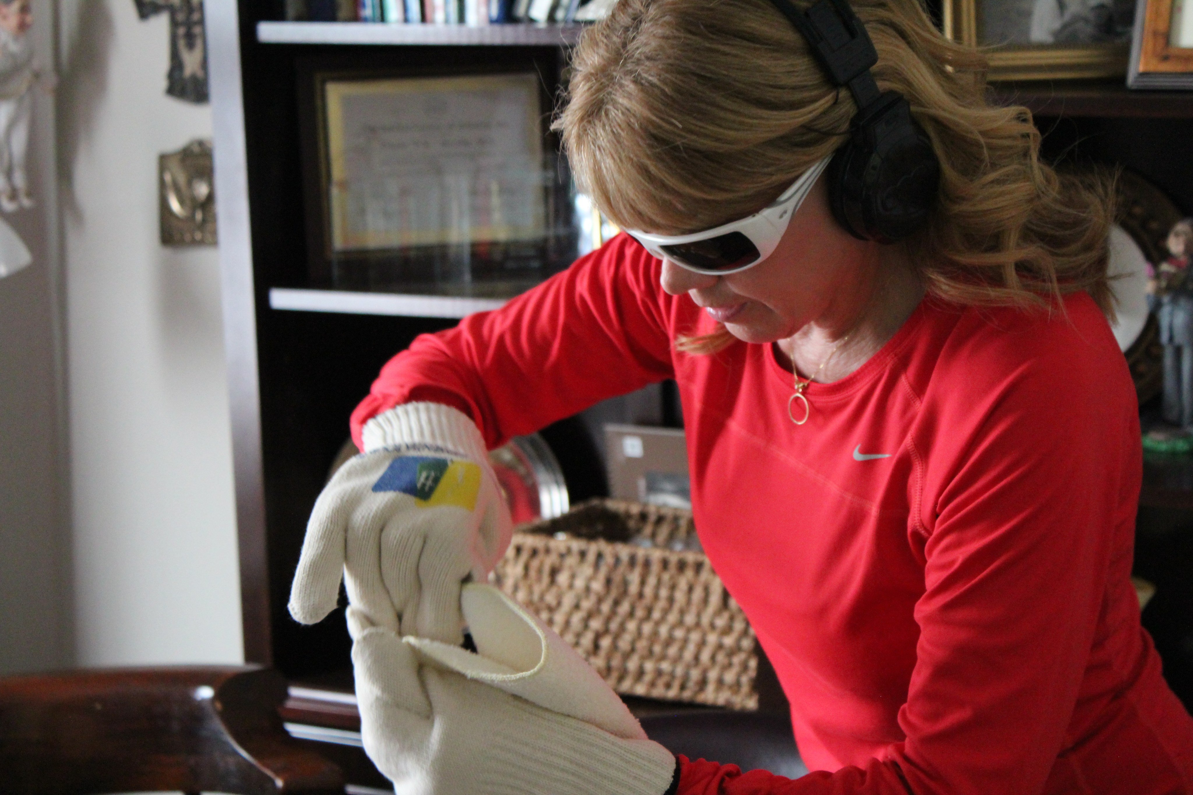 An employee of Second Wind Dreams in the US struggles with a simple folding task while wearing gloves, which interfere with dexterity - as arthritis might - on a virtual dementia tour that simulates the challenges of the condition. Photo: Second Wind Dreams