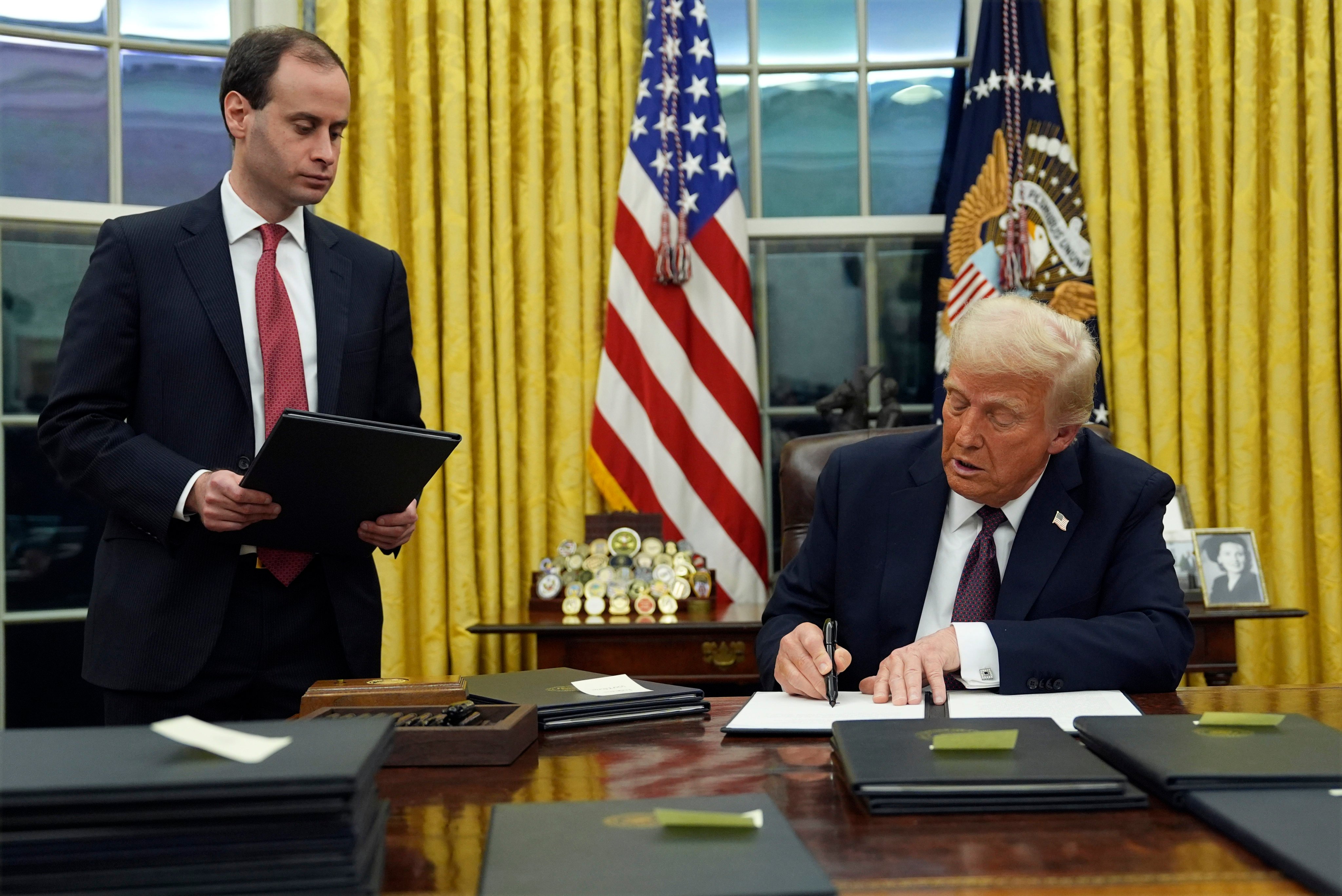 US President Donald Trump signs an executive order on TikTok in the Oval Office on Monday. Photo: AP