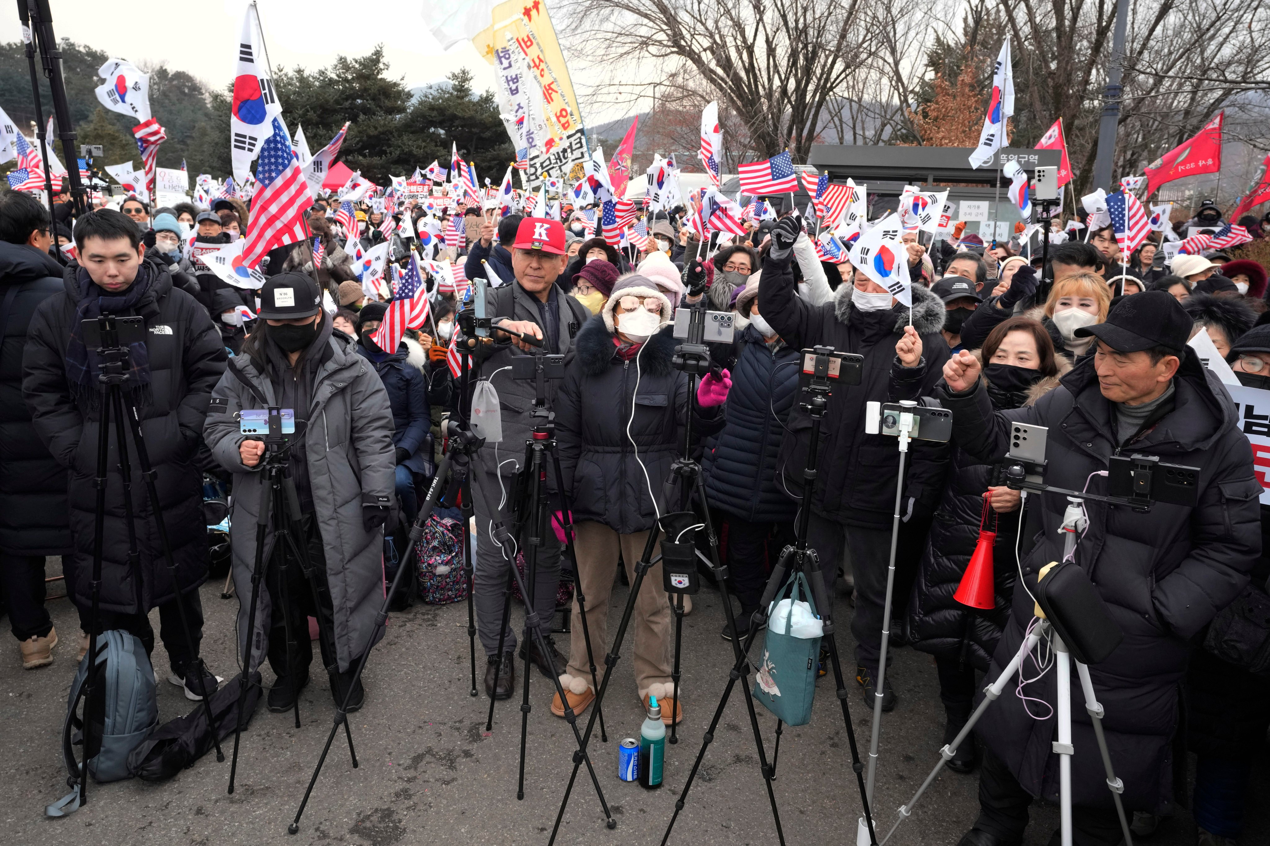 YouTubers supporting Yoon Suk-yeol, South Korea’s impeached president, hold a rally in Uiwang, South Korea, on Thursday. Photo: AP