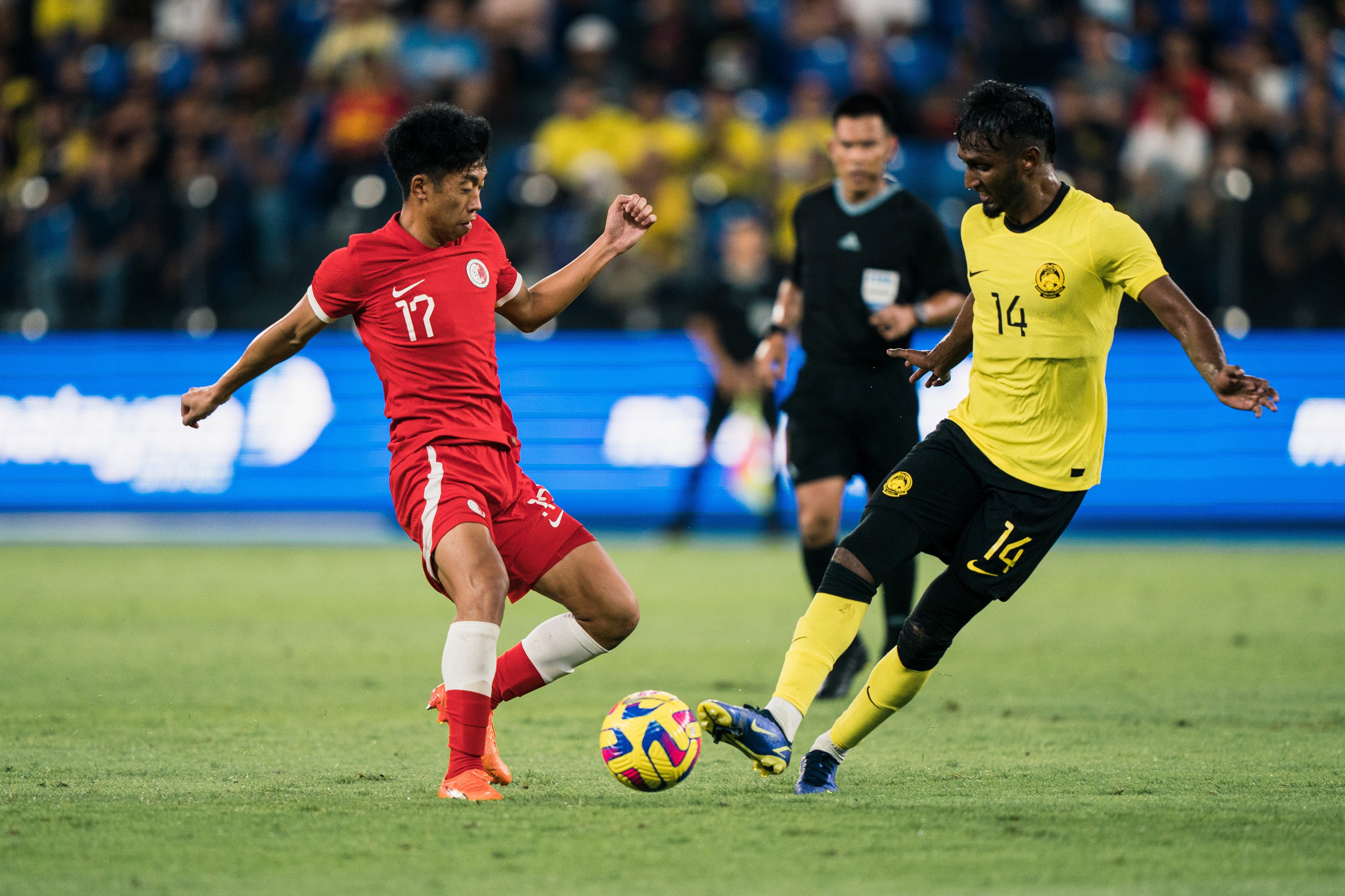 Anson Wong (left) in action during his Hong Kong debut, against Malaysia in 2023. Photo: HKFA