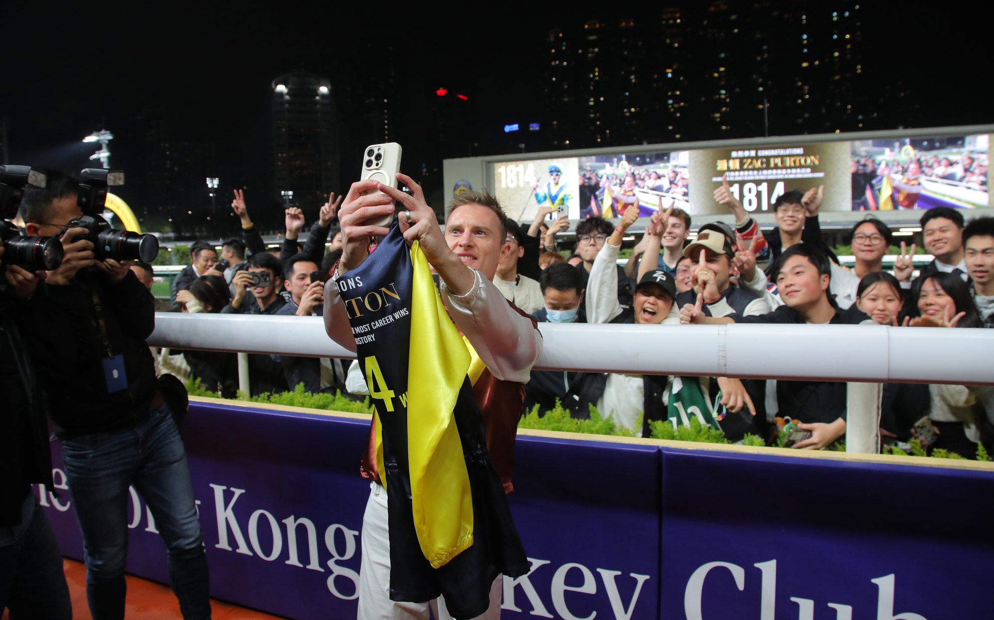 Zac Purton poses for a photo with fans at the Valley on Wednesday night.