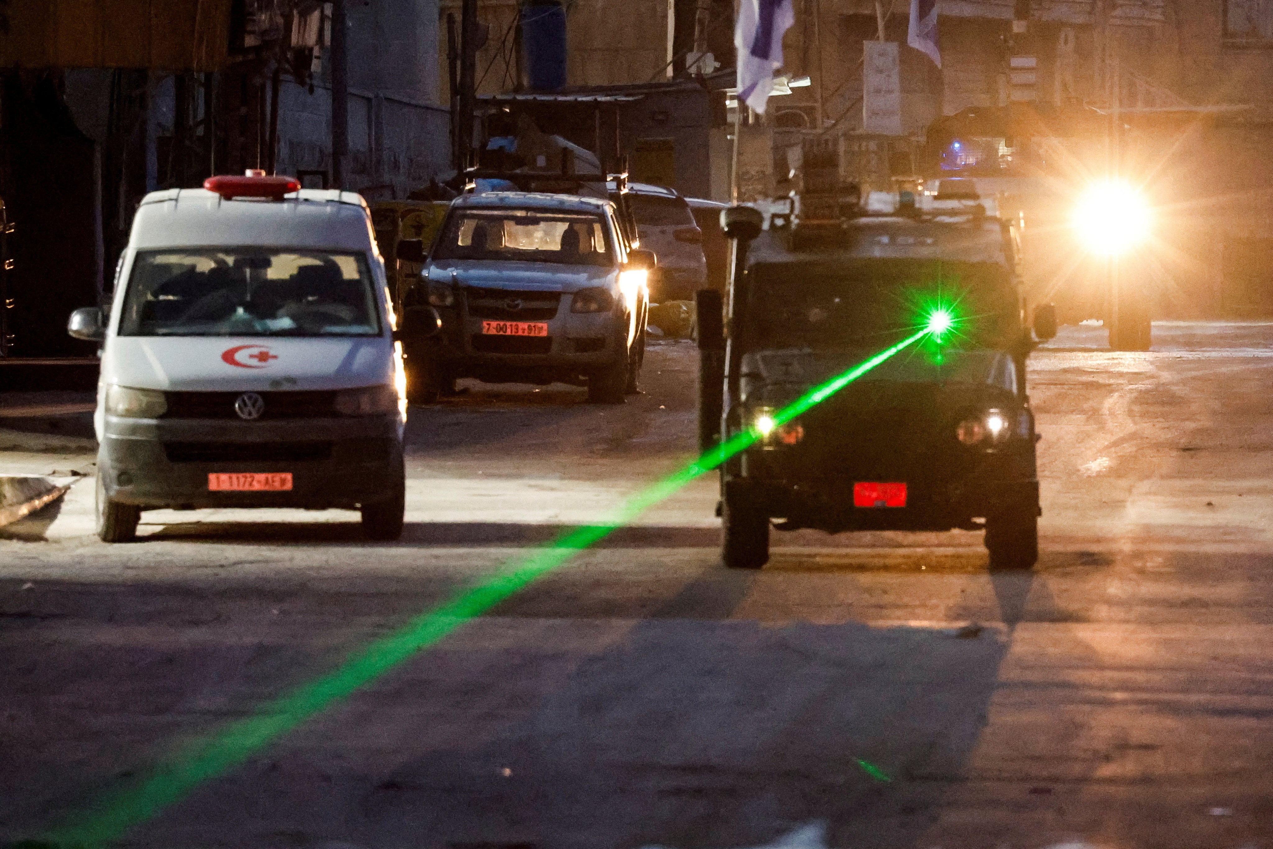 An Israeli military vehicle uses a laser, on the day of an Israeli raid in Jenin, in the Israeli-occupied West Bank. Photo: Reuters