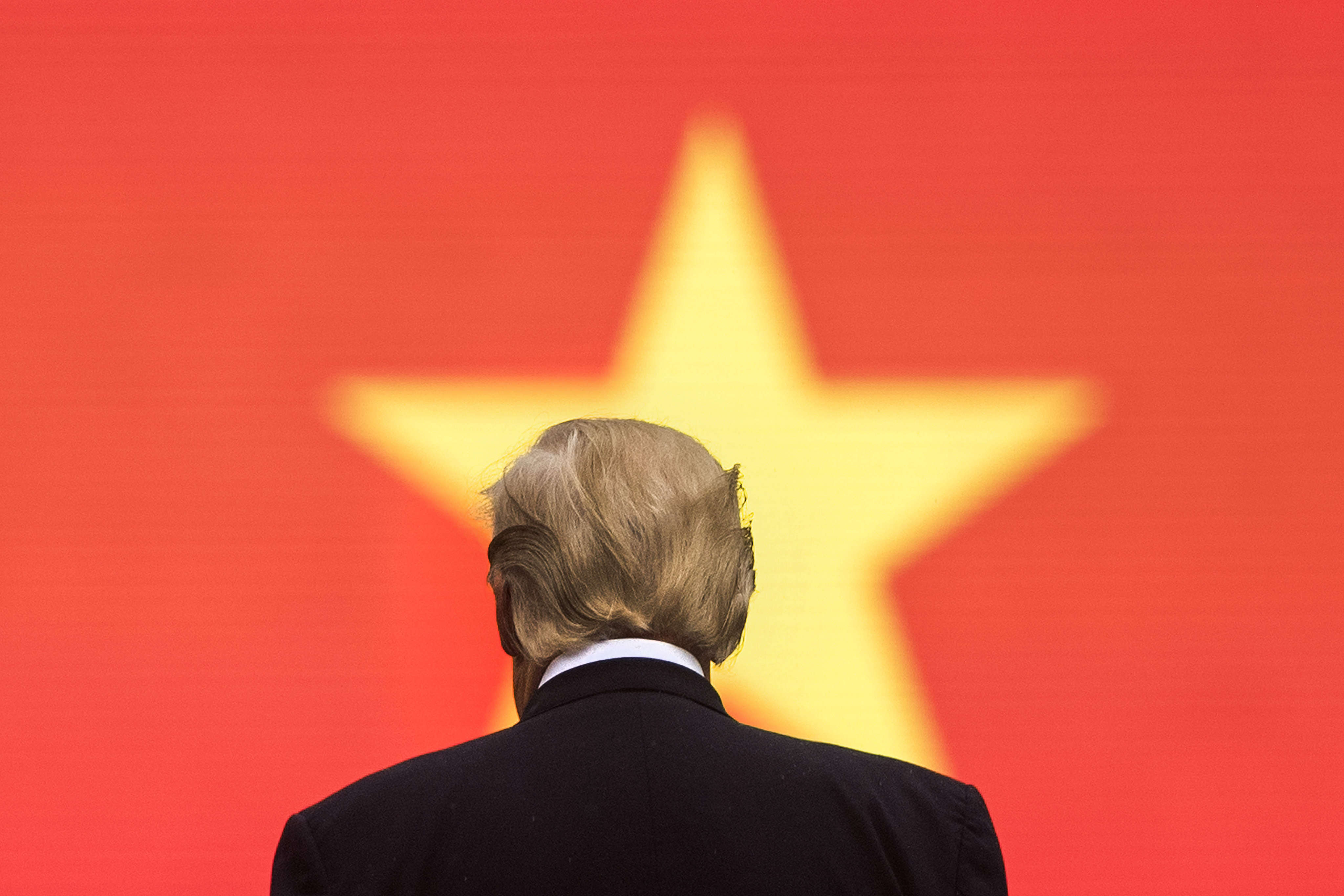 US President Donald Trump stands in front of the Vietnamese flag during an arrival ceremony in Hanoi in 2017. Photo: AFP