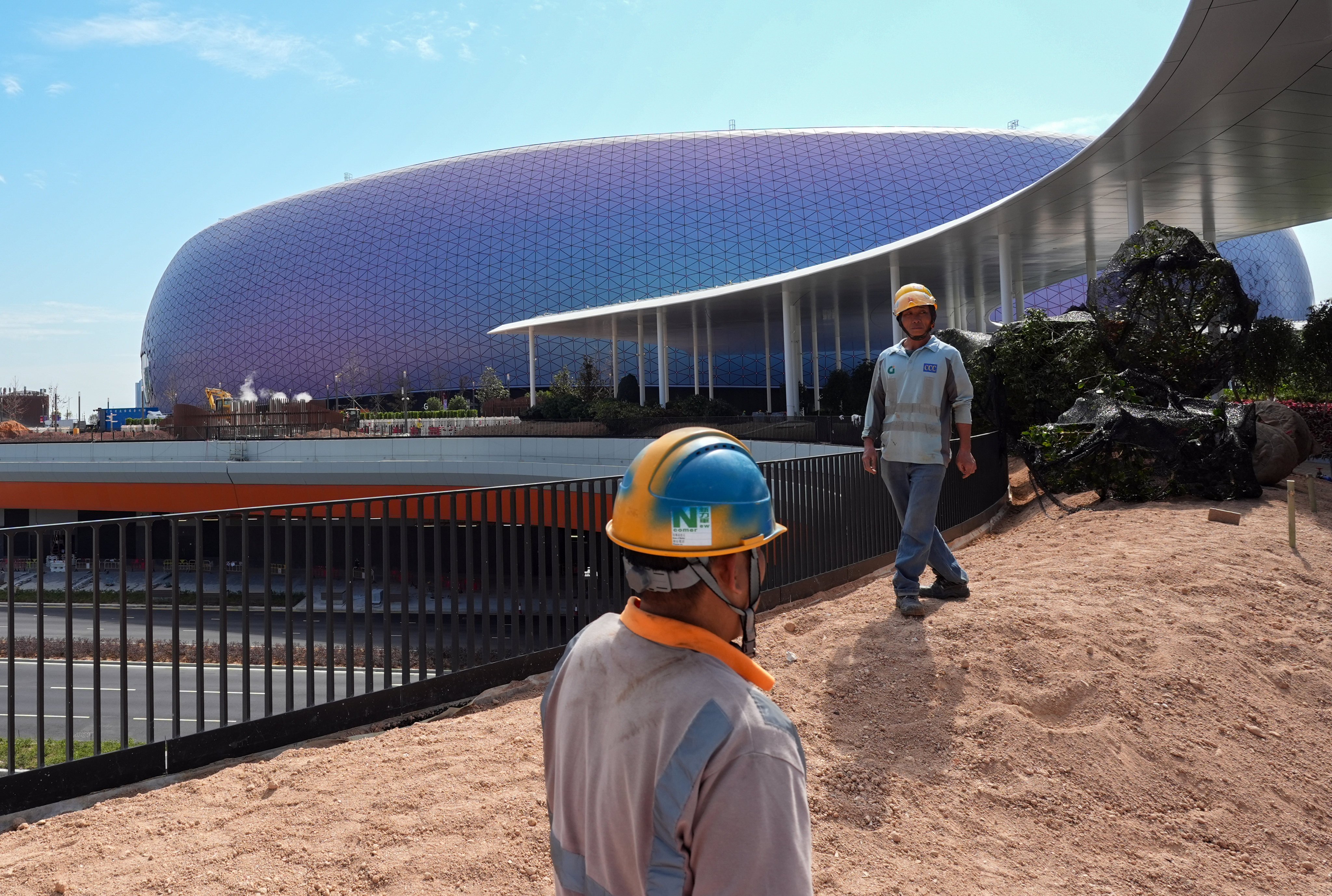 Workers outside the main stadium of Kai Tak Sports Park on January 15. Photo: Eugene Lee